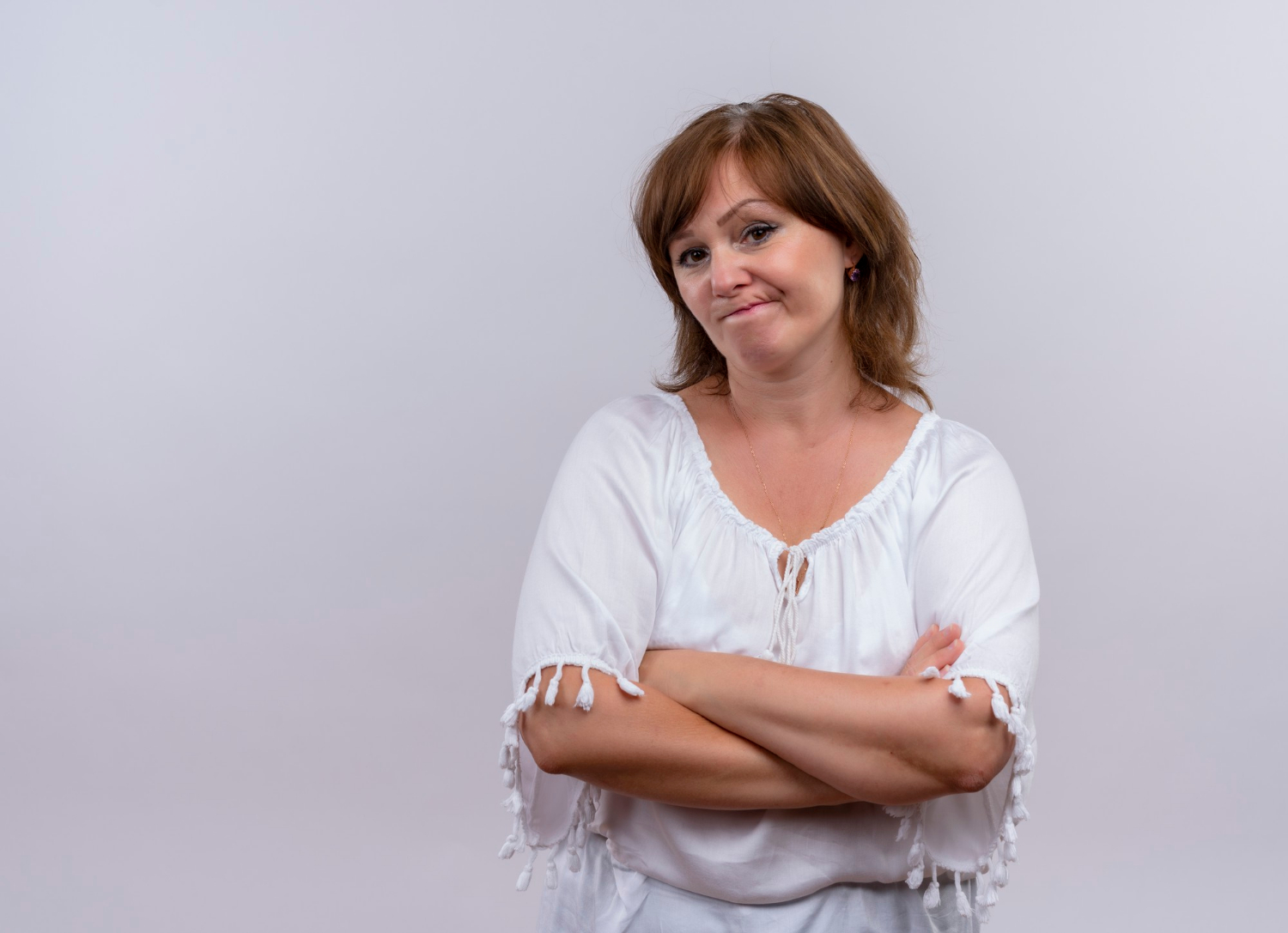 A thoughtful woman with her arms crossed | Source: Freepik