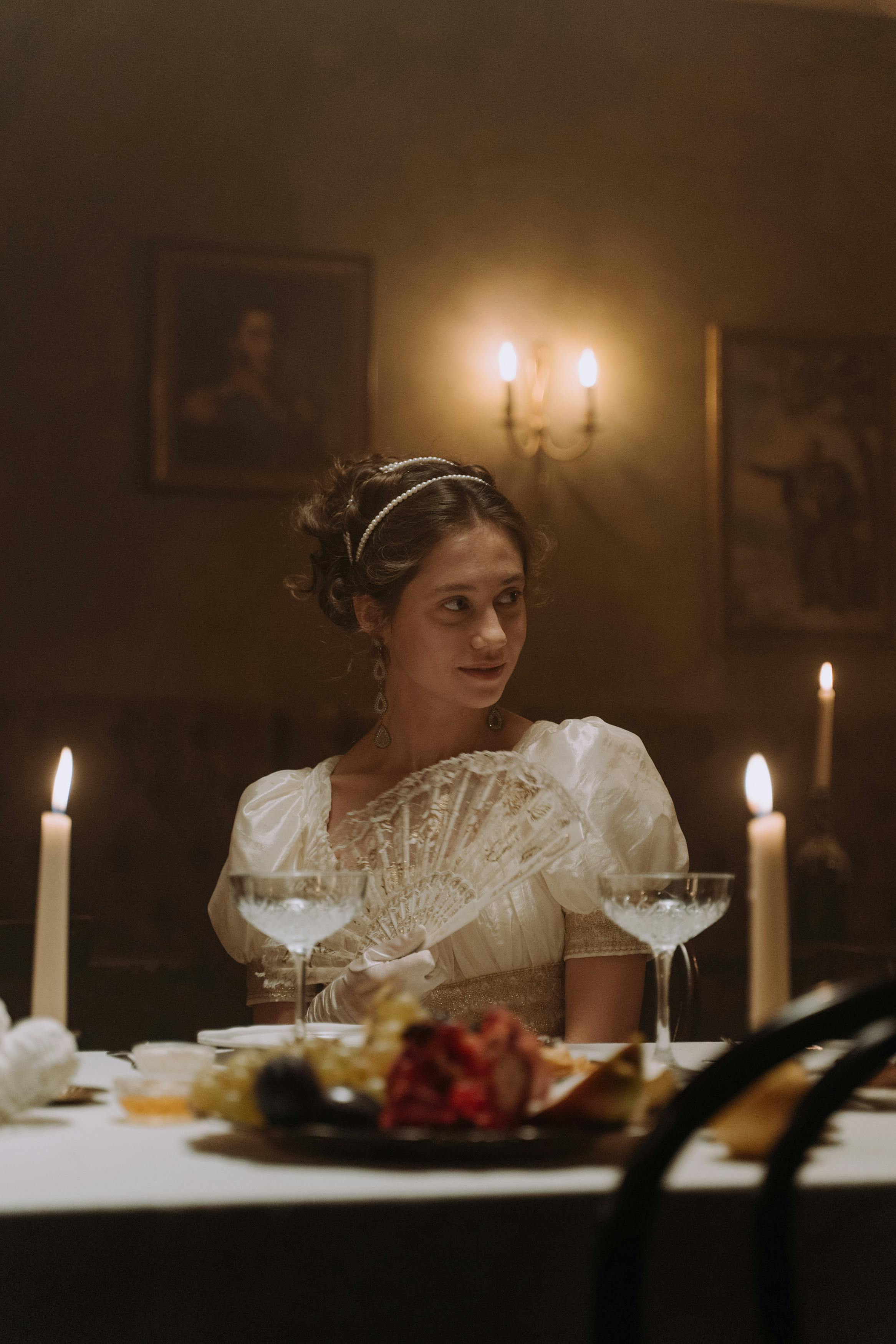 Woman seated at a dinner table staring at someone off camera | Source: Pexels