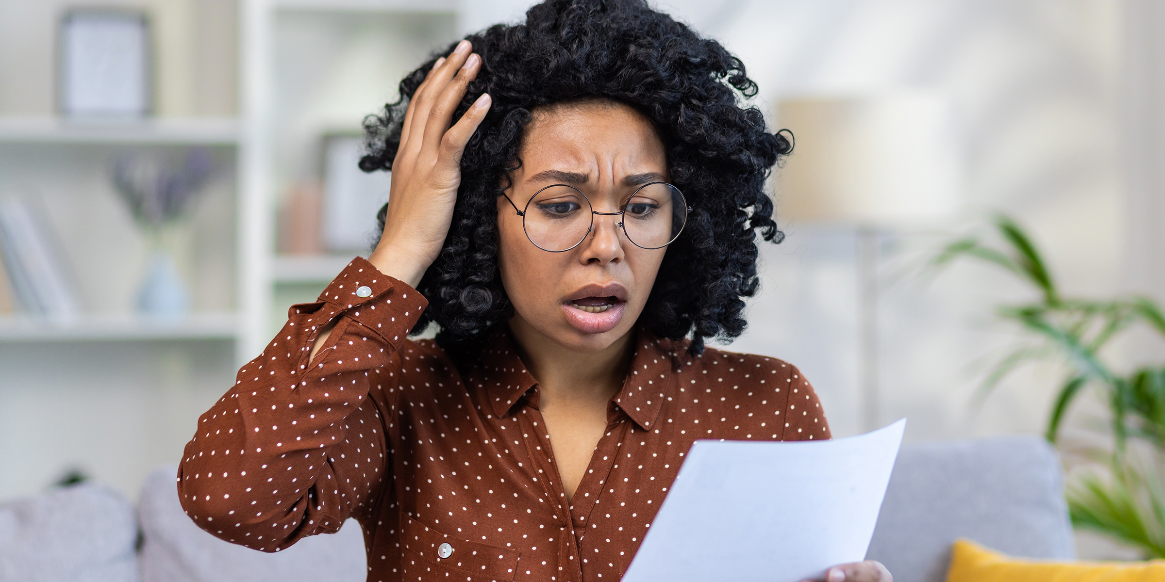 A woman looking at a document | Source: Shutterstock