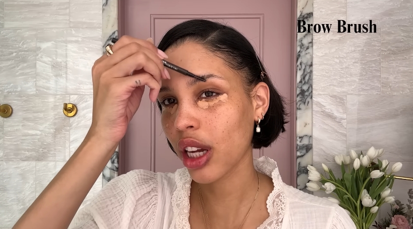Nara Smith doing her makeup routine from a video dated December 12, 2024. | Source: YouTube/Vogue