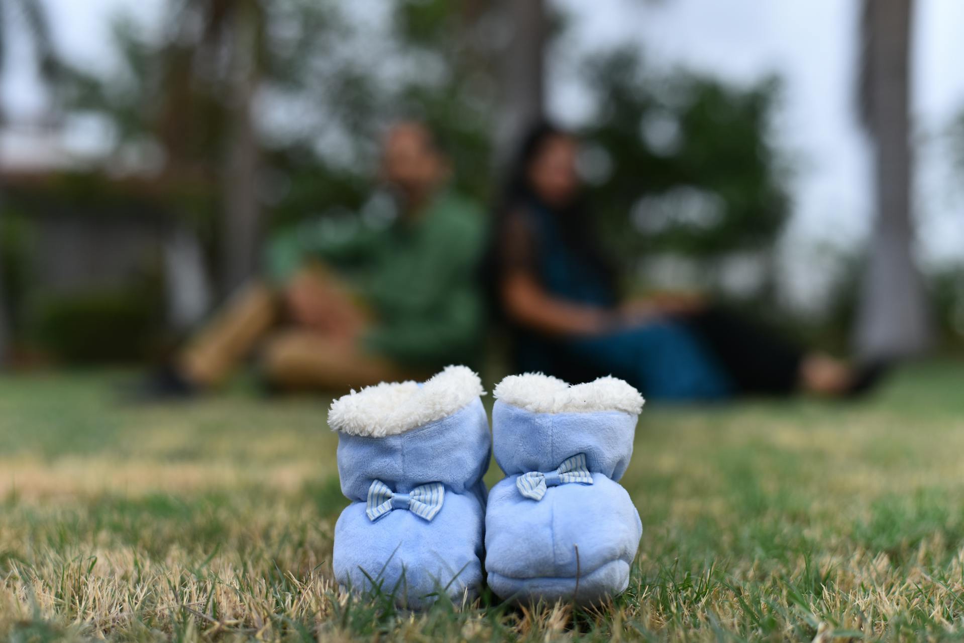 A close-up of baby shoes lying on grass | Source: Pexels
