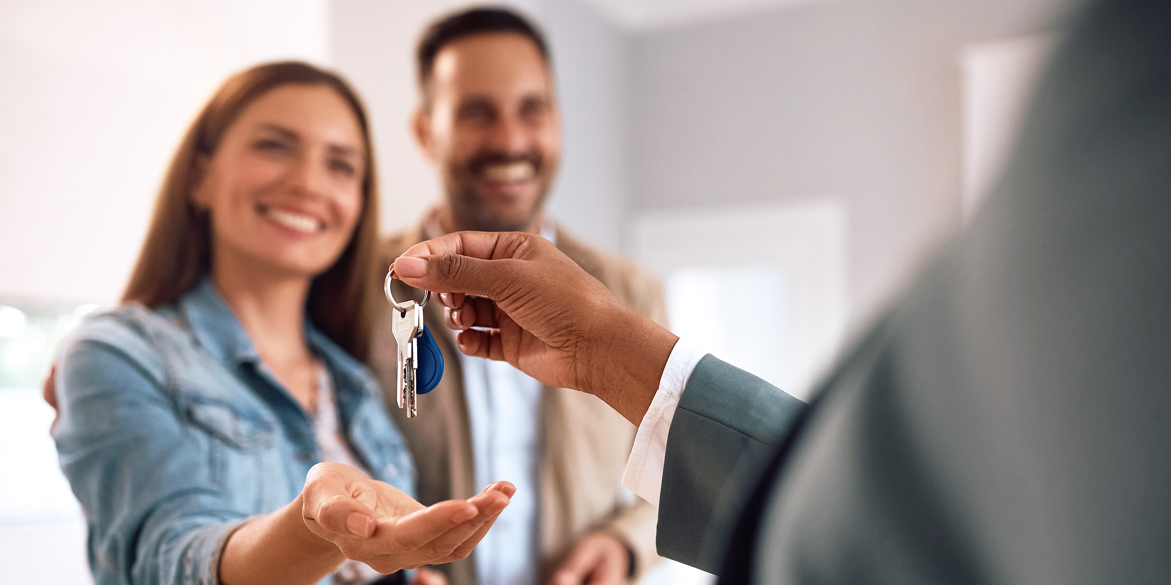 Delighted couple receiving keys to their new home | Source: Shutterstock