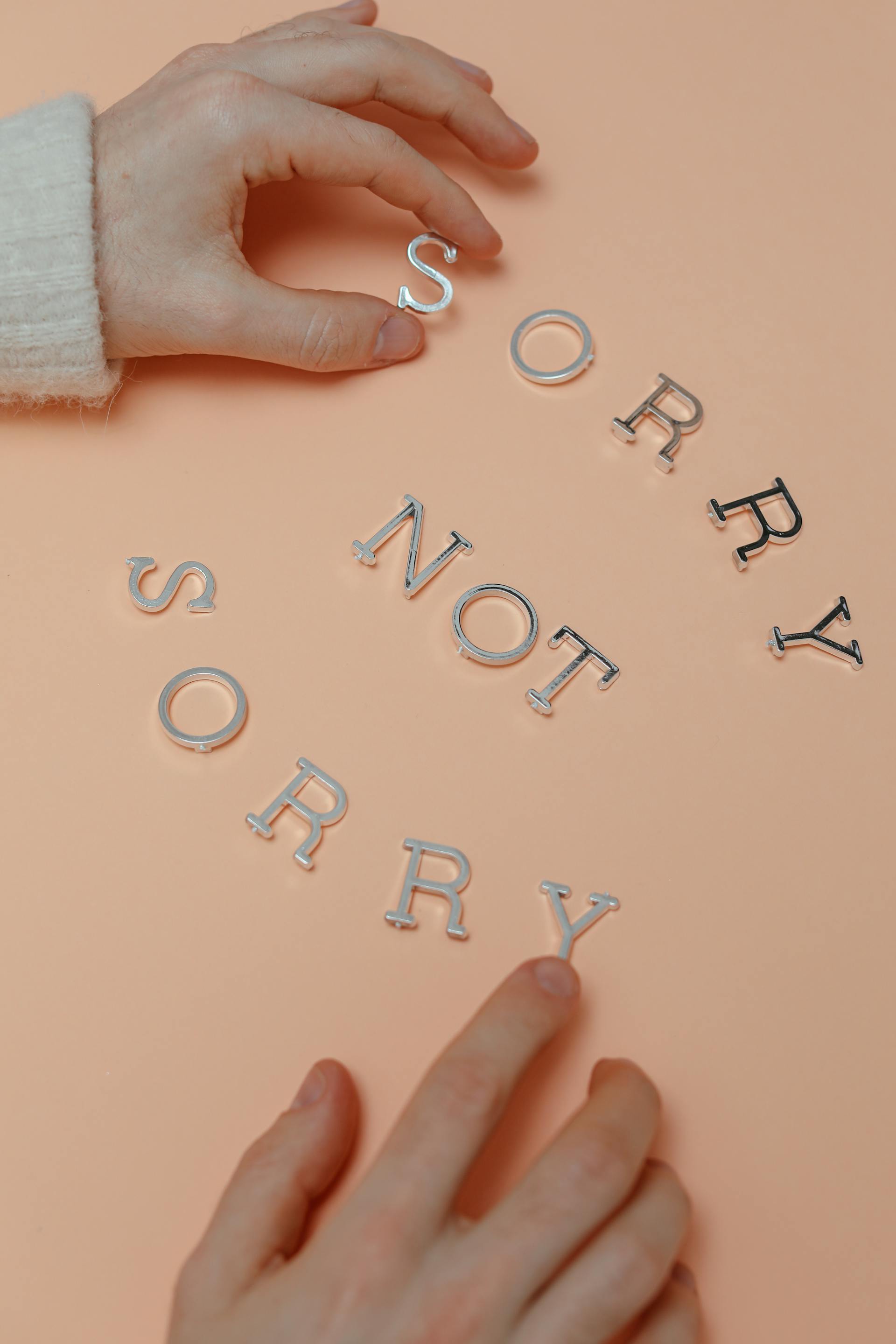 A close-up shot of a person forming a phrase with letters | Source: Pexels