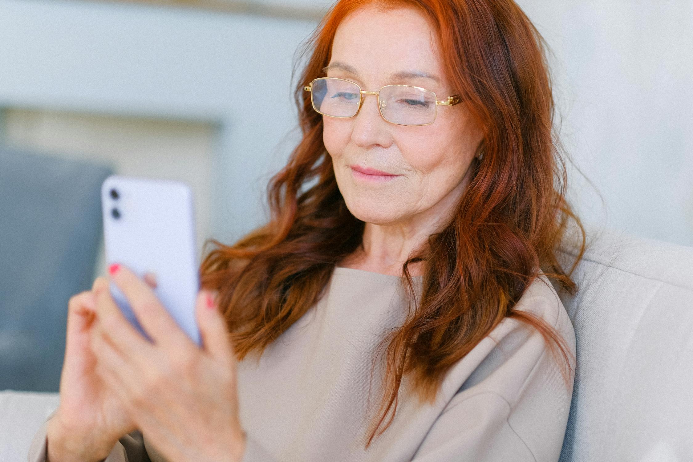 A mature woman looking at her phone | Source: Pexels