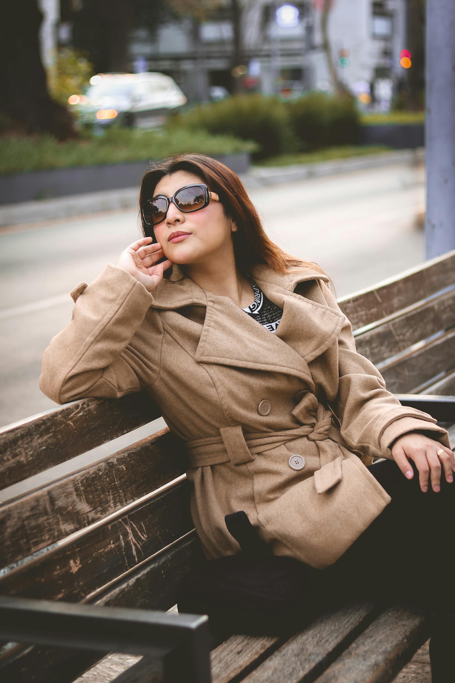 A woman sitting on a bench looking at something | Source: Pexels