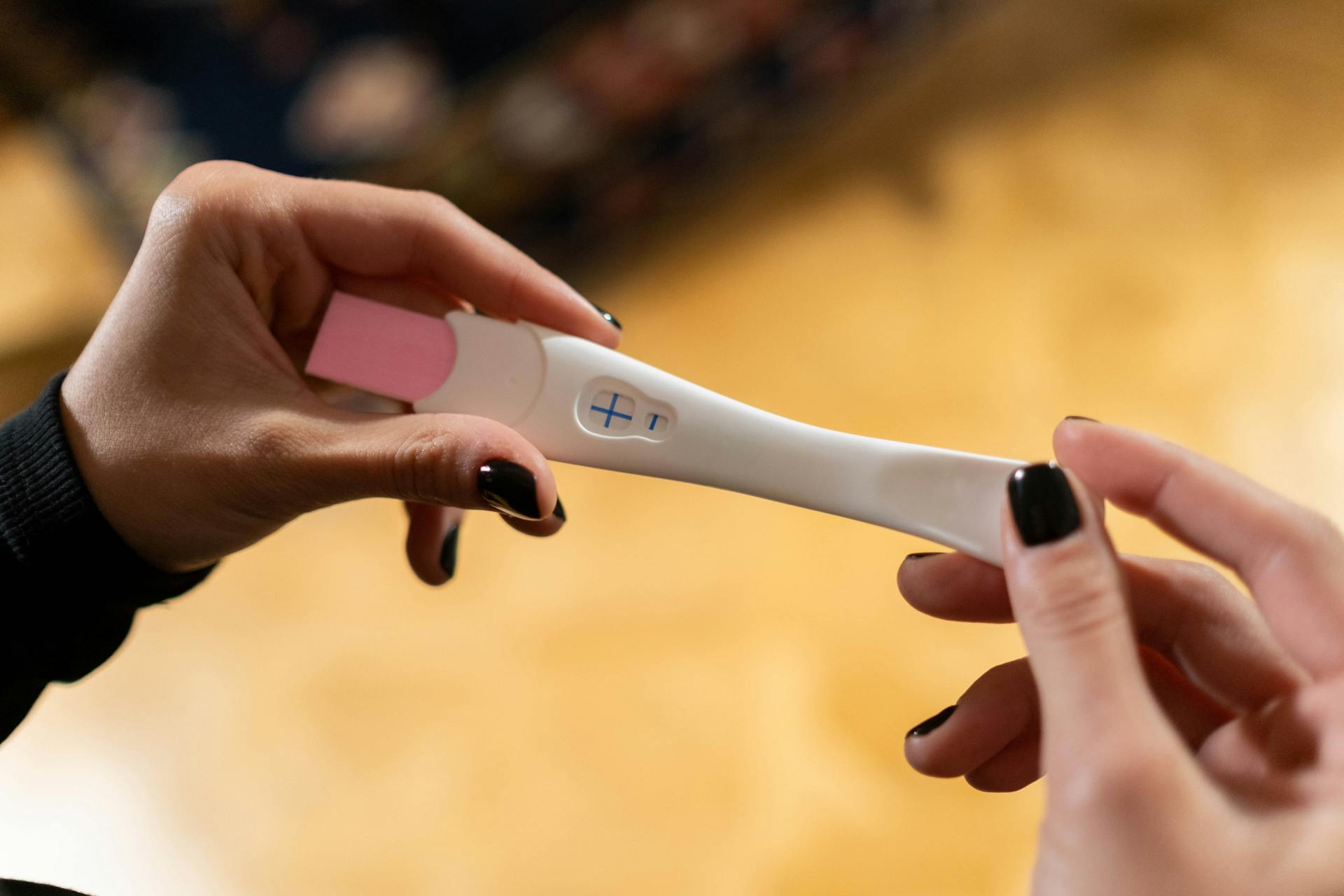 A woman looking at a pregnancy test | Source: Pexels