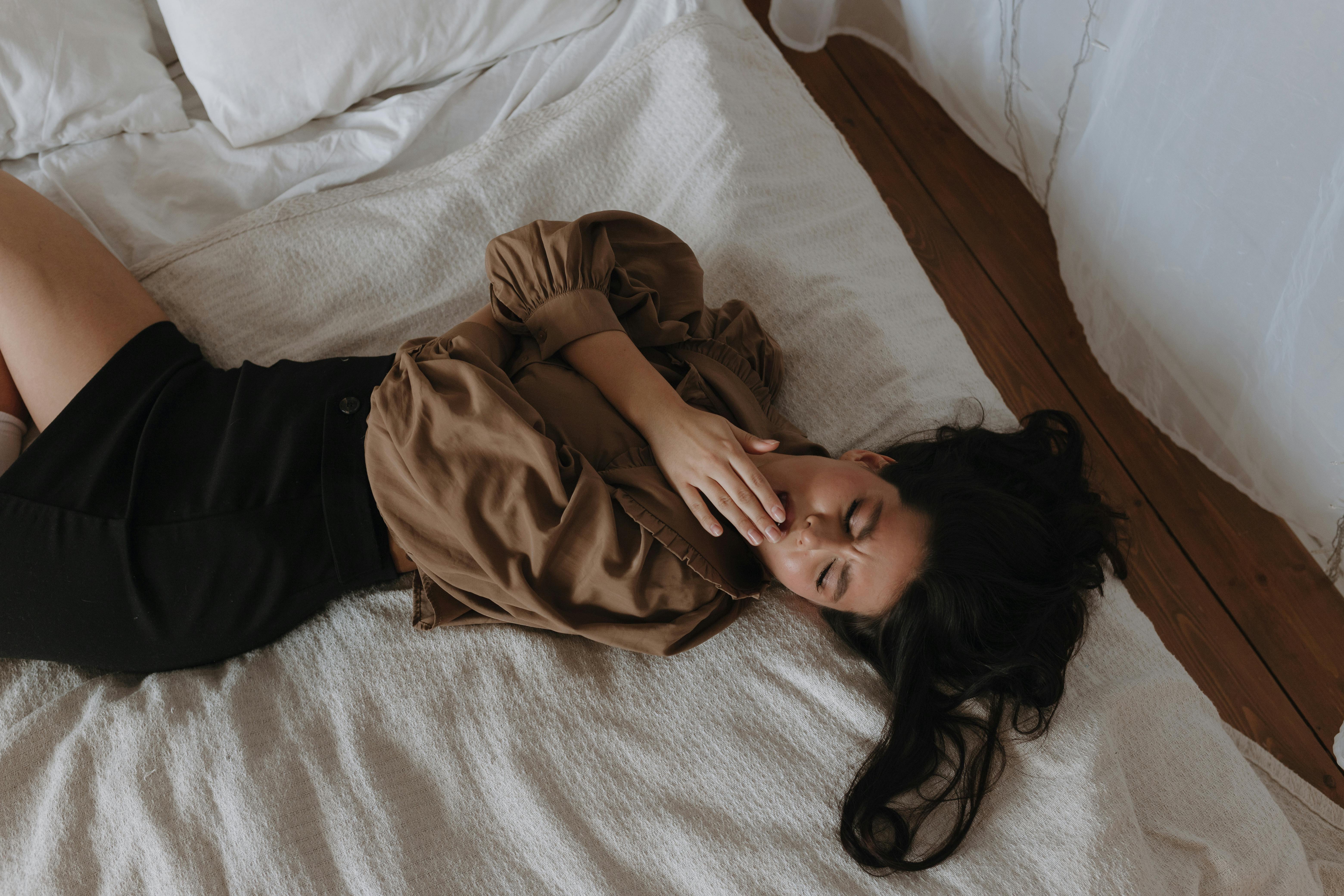 Woman yawning in bed | Source: Pexels