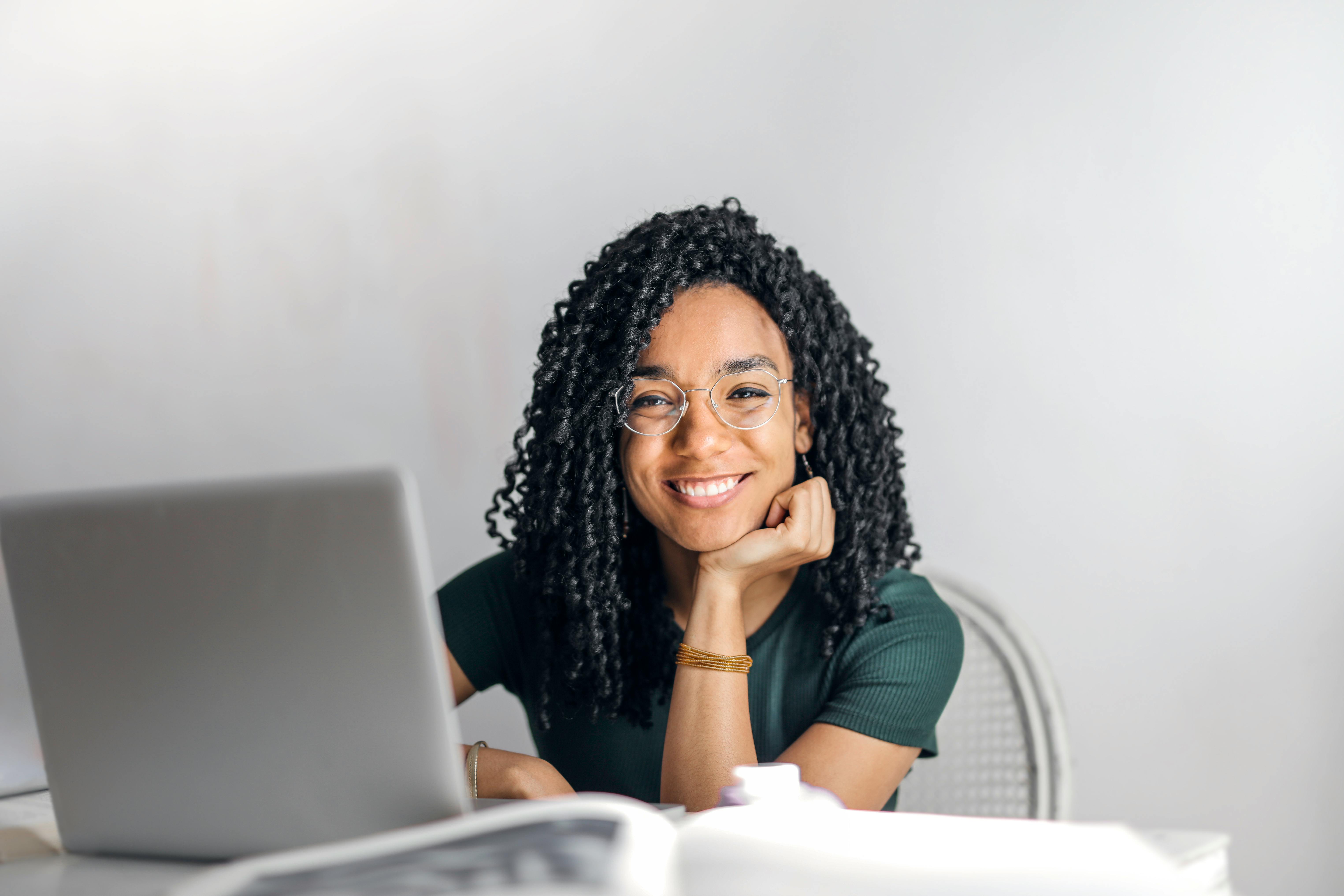 A smiling woman at work | Source: Pexels