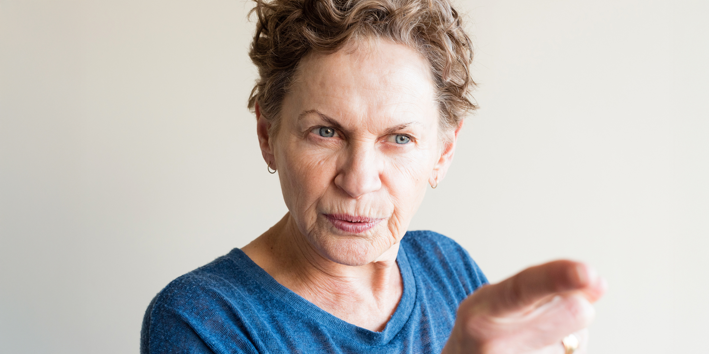 An old woman pointing a finger | Source: Shutterstock