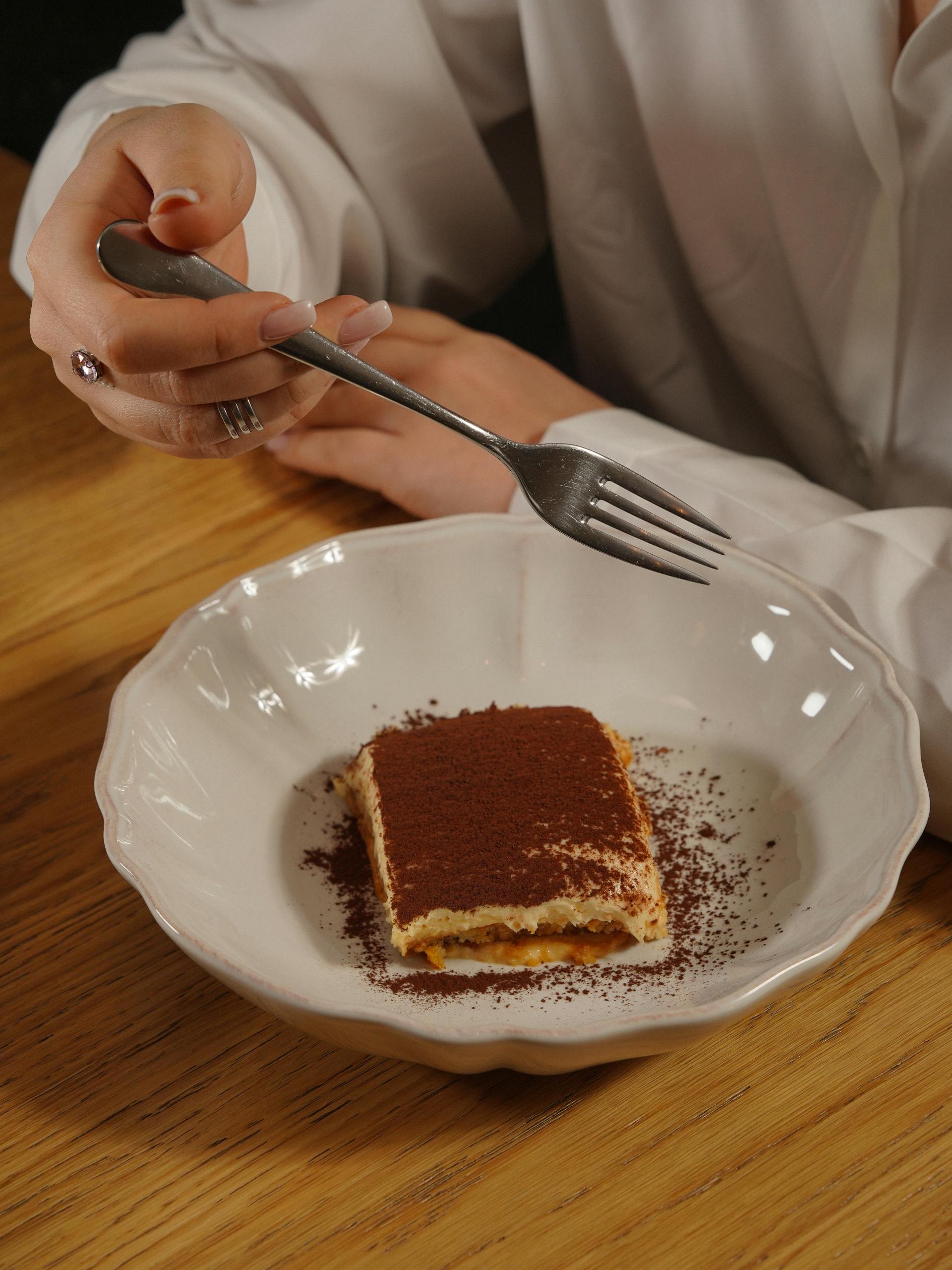 A woman eating tiramisu | Source: Pexels