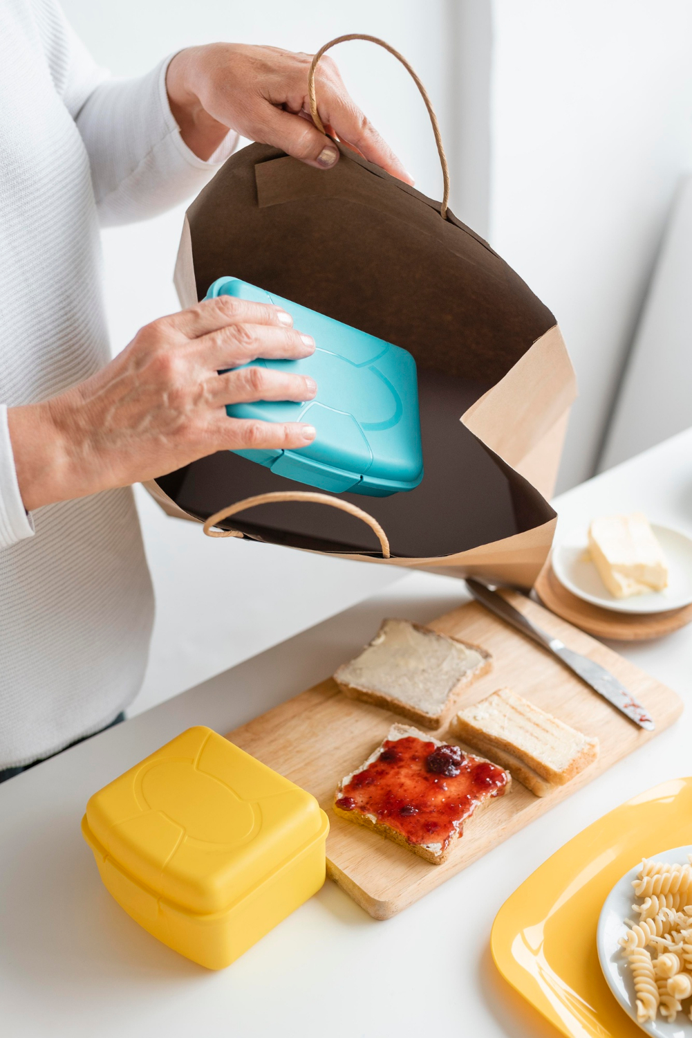 A senior woman packing lunch | Source: Freepik