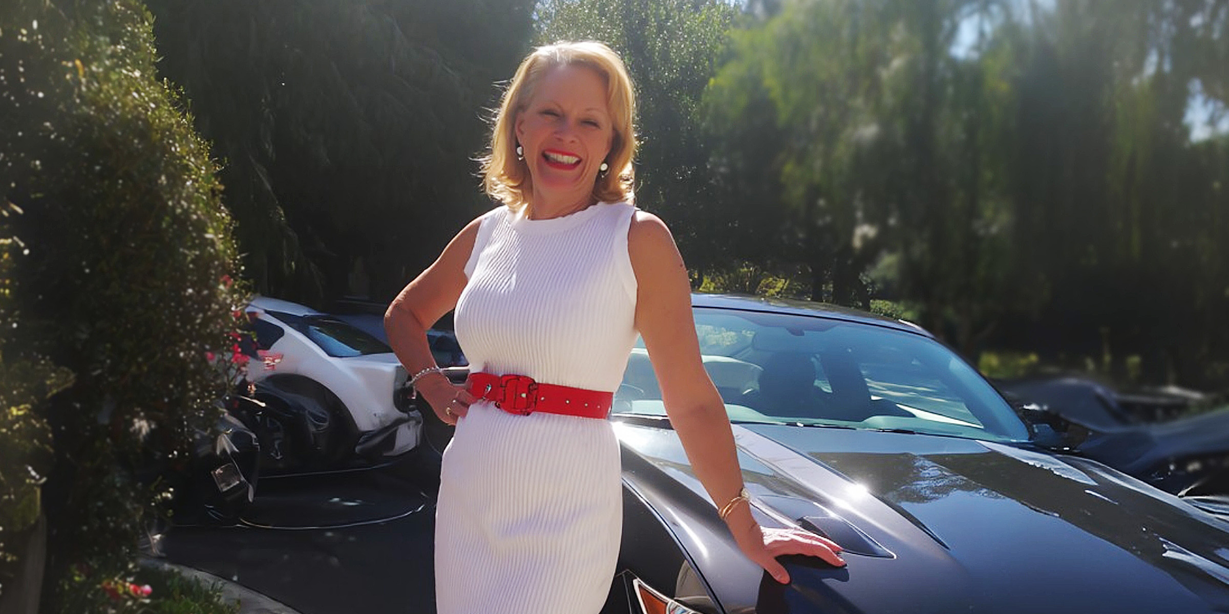 A happy woman standing by a new car | Source: Amomama
