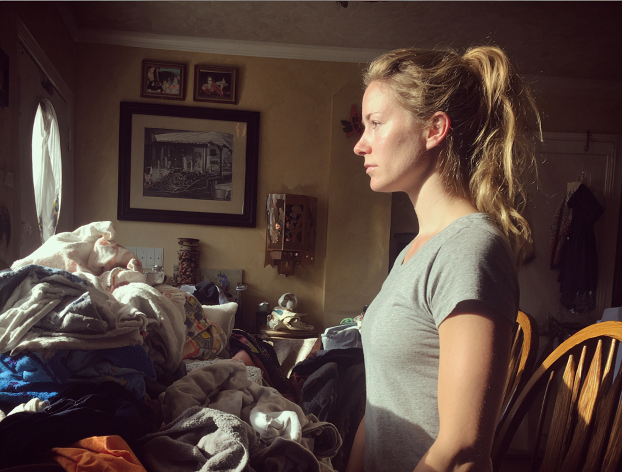 A woman folding laundry in a dining room | Source: Midjourney