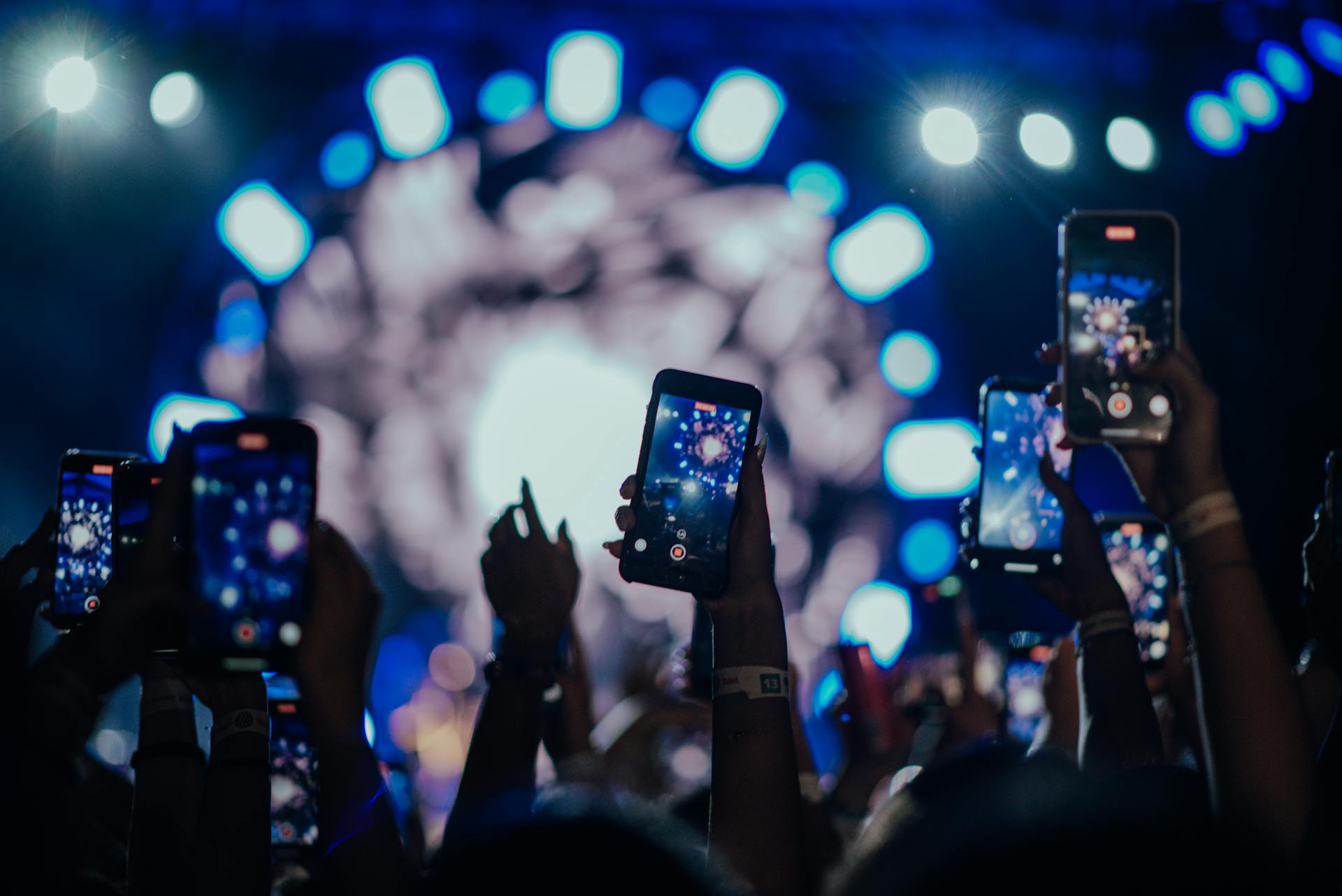 A group of people holding their phones at a celebratory event | Source: Pexels