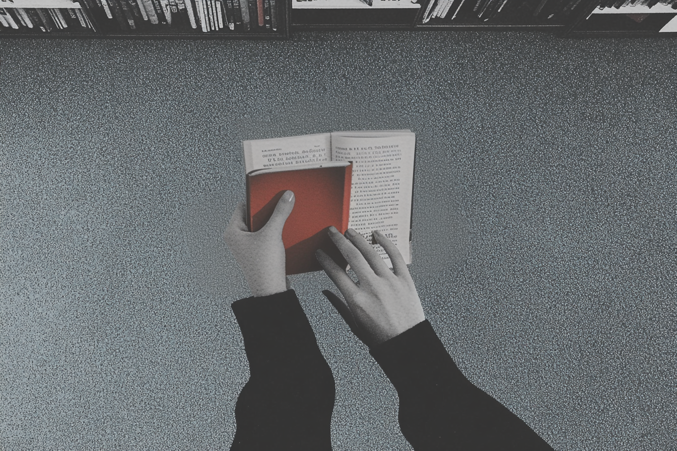 A woman holding books in a library | Source: Midjourney