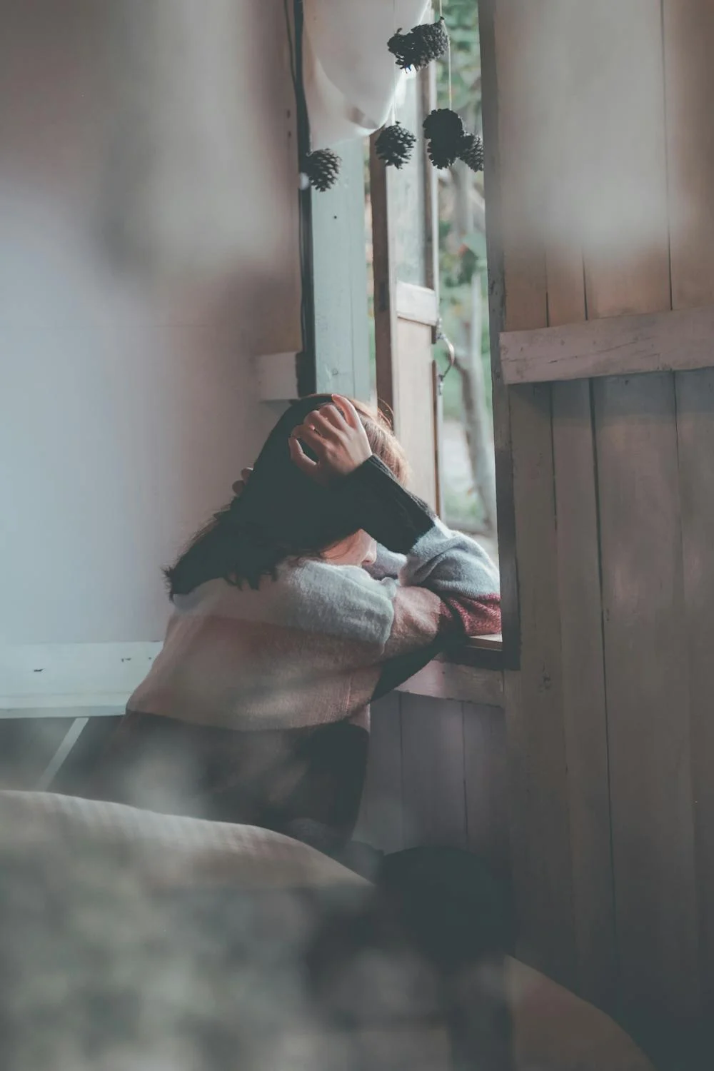 A sad woman looking out of the window | Source: Pexels