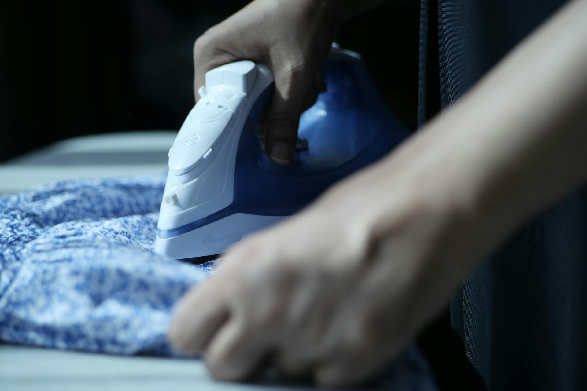 A person ironing a piece of cloth | Source: Pexels