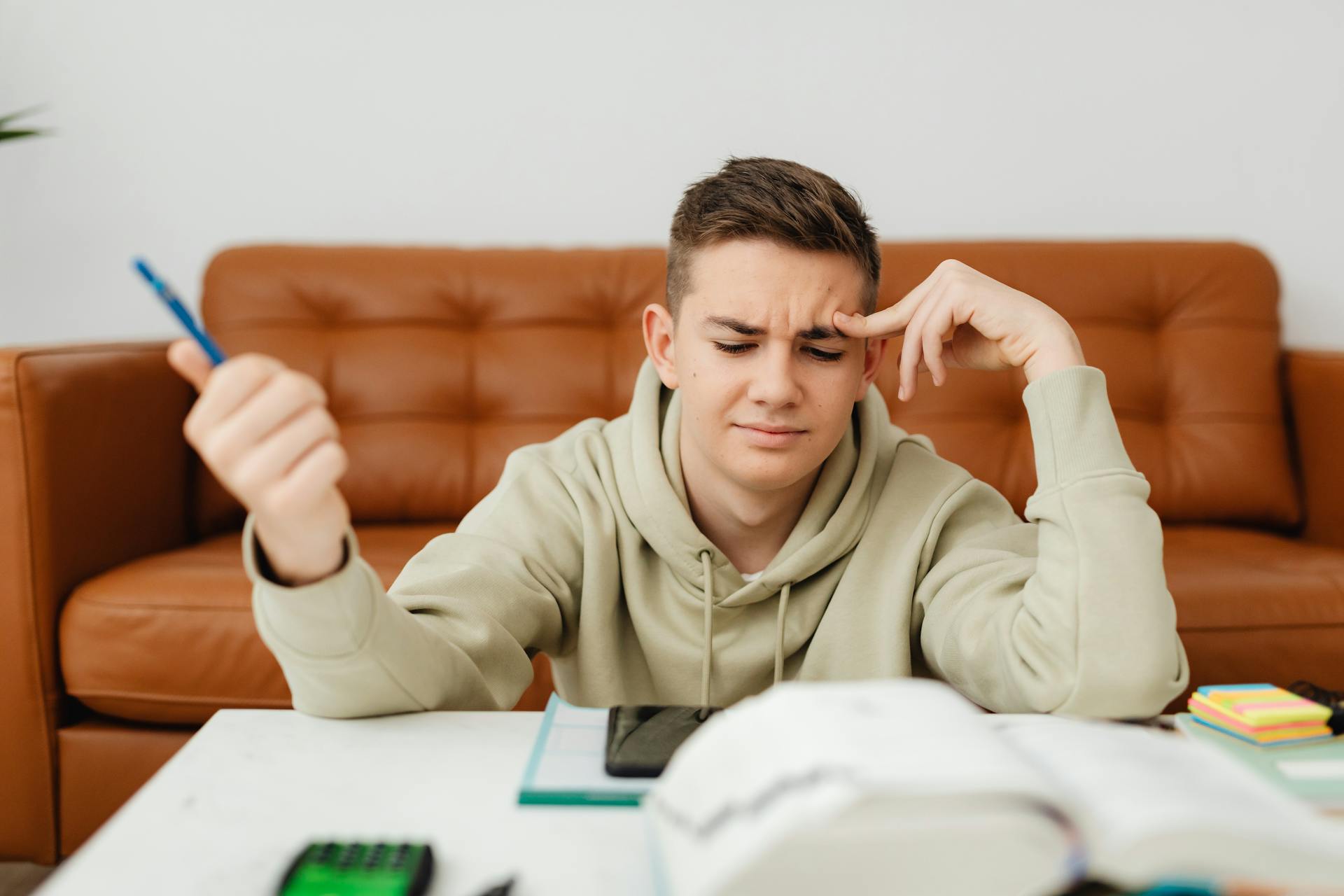 A determined teenager doing his school work | Source: Pexels