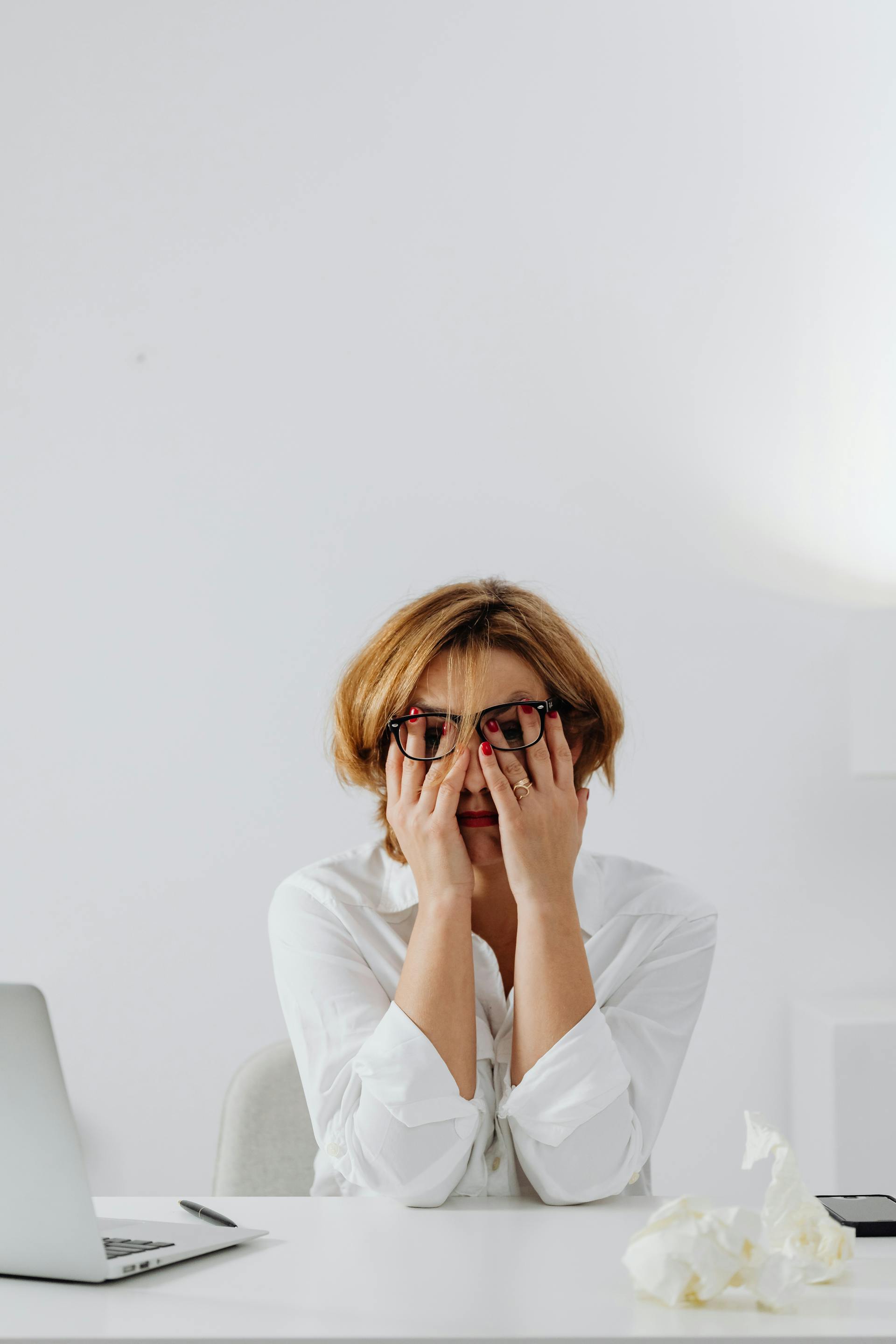A sad woman covering her face with her hands | Source: Pexels