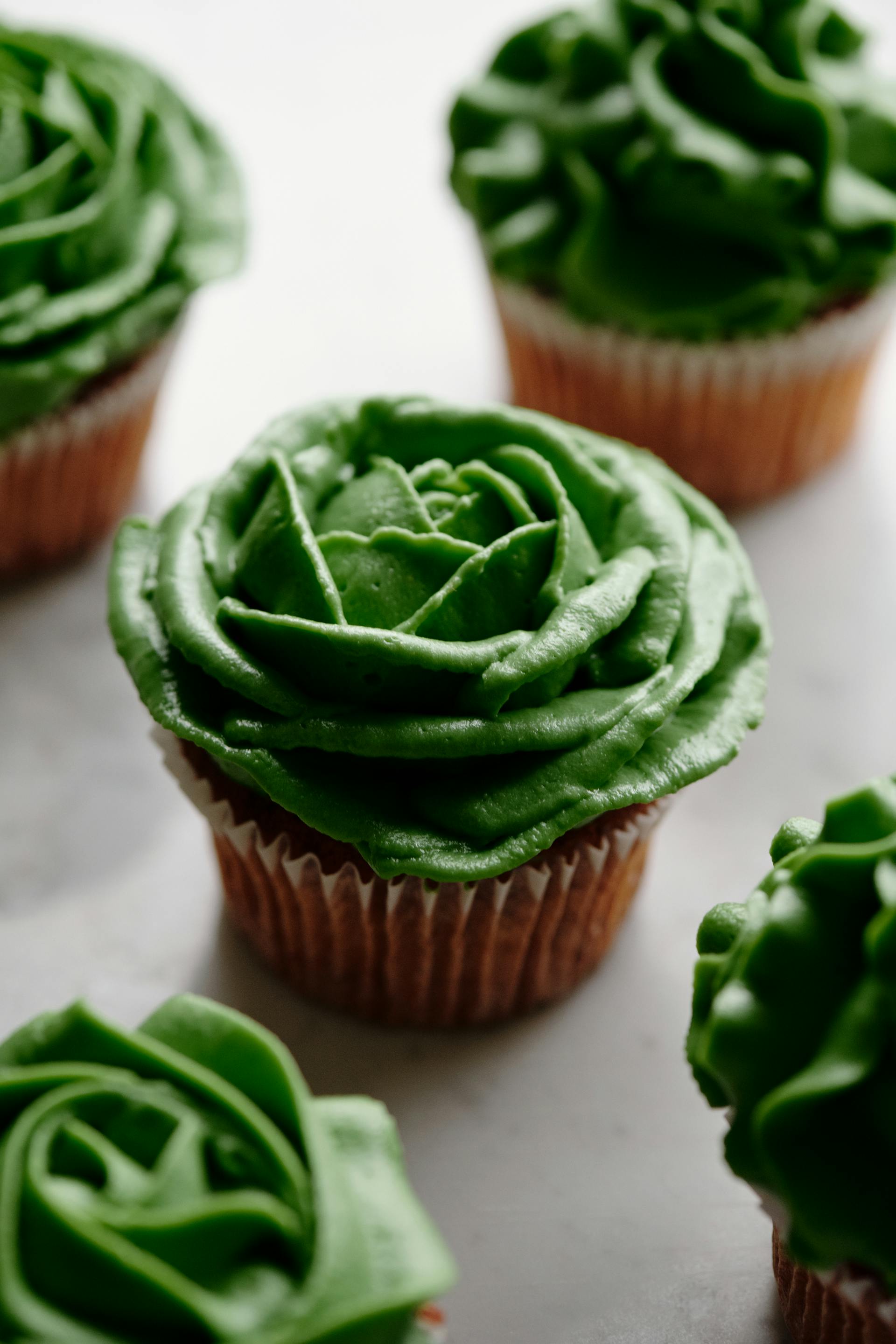 A close-up shot of cupcakes with green frosting | Source: Pexels