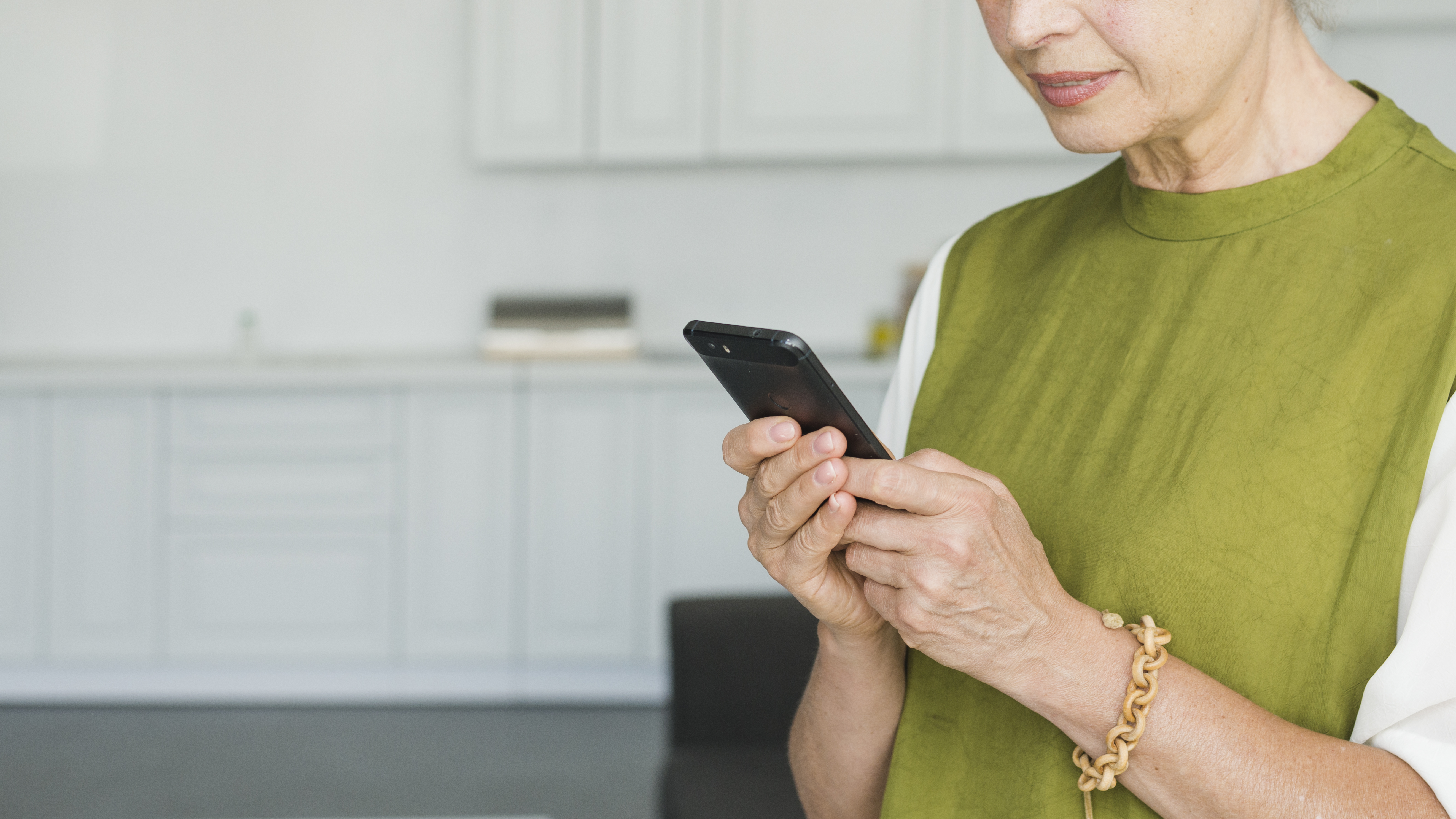 A closeup shot of a woman looking at her phone | Source: Freepik