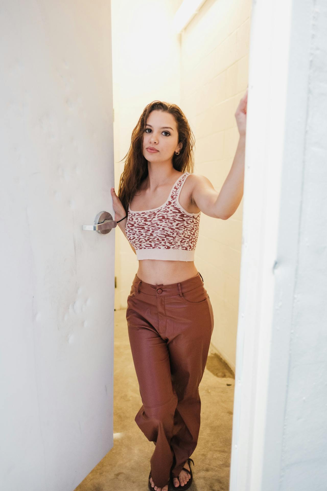 A woman standing at the doorway | Source: Pexels