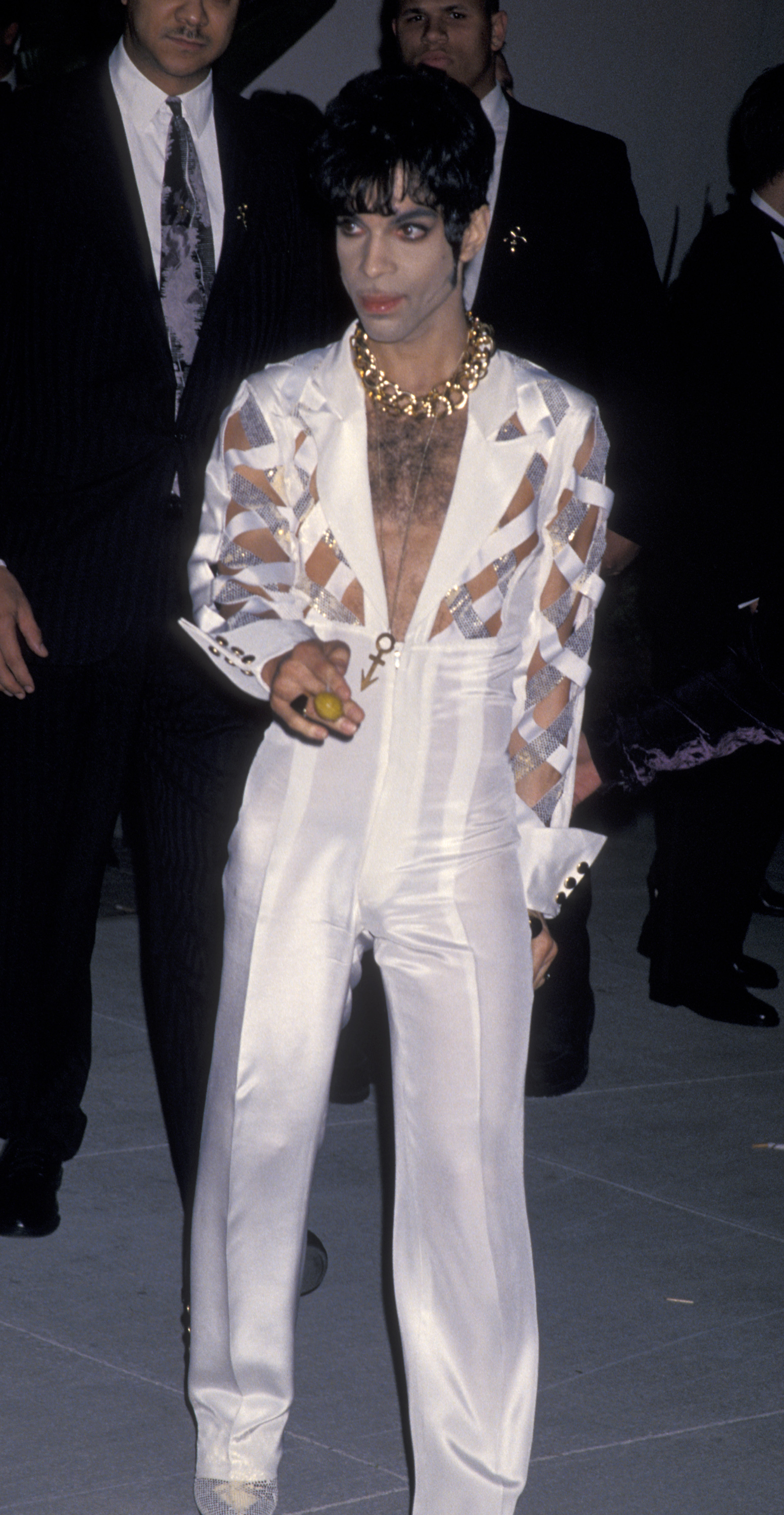 Prince suited up in a white cut-out jumpsuit for the first Vanity Fair Oscar Party at Morton's Restaurant in West Hollywood, California, in 1994.