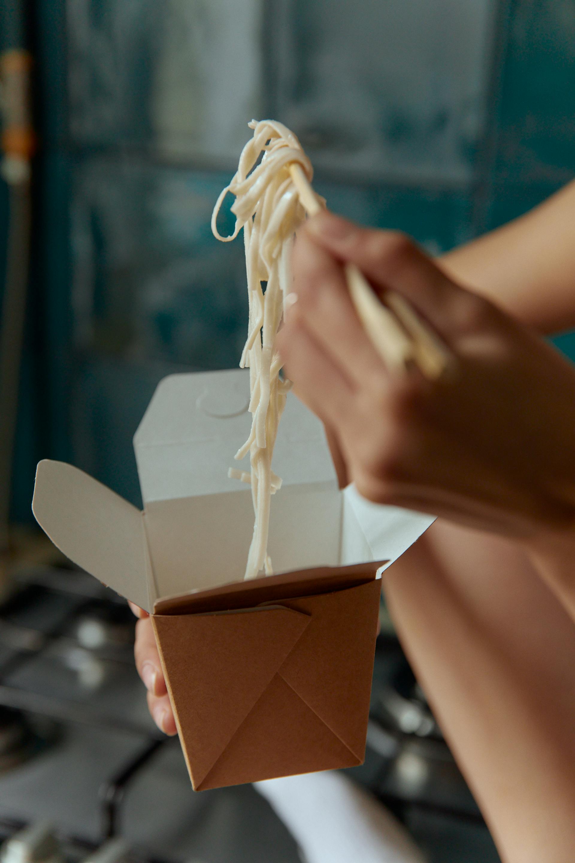 A woman eating Chinese takeout | Source: Pexels