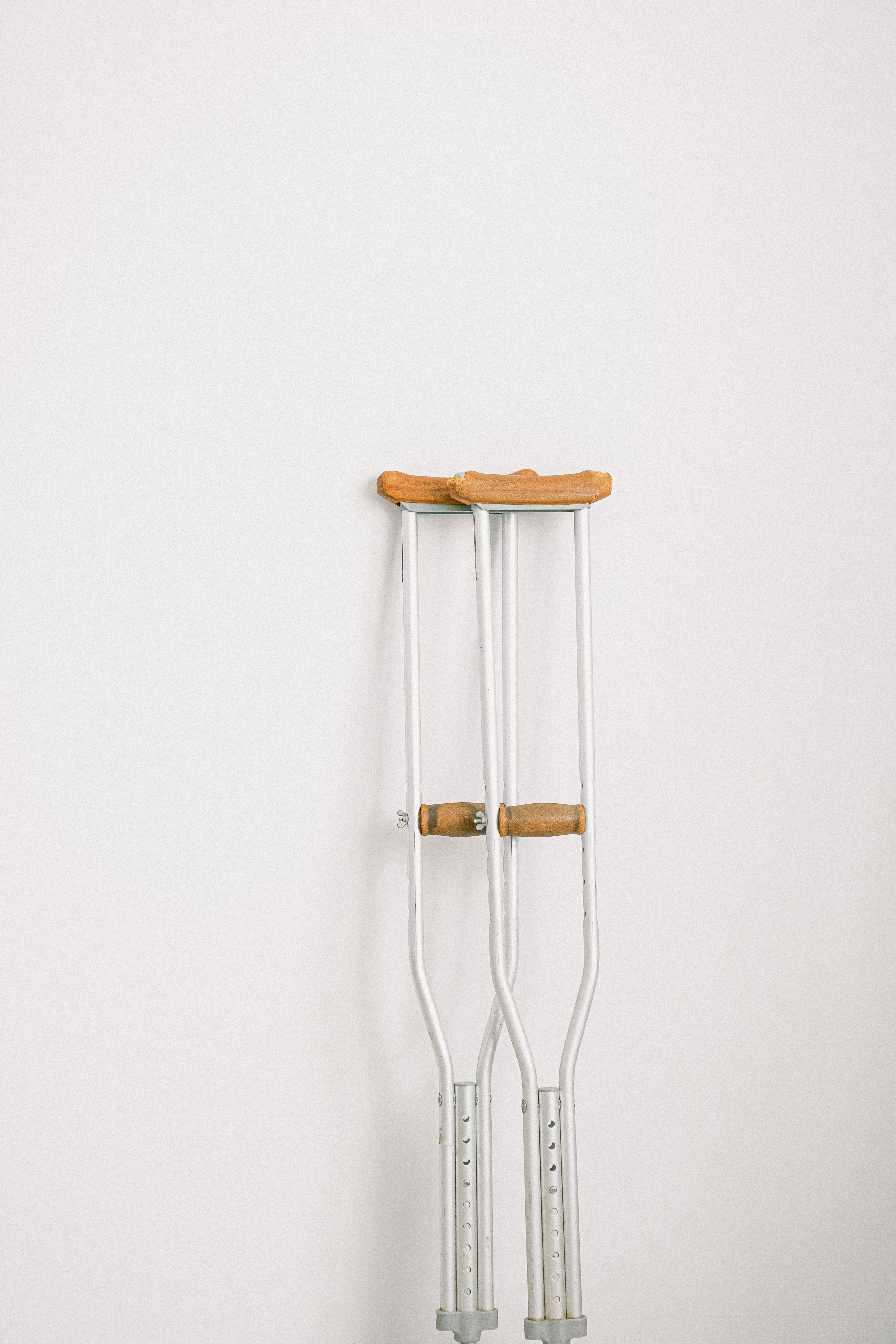 A pair of crutches leaning against a wall | Source: Unsplash