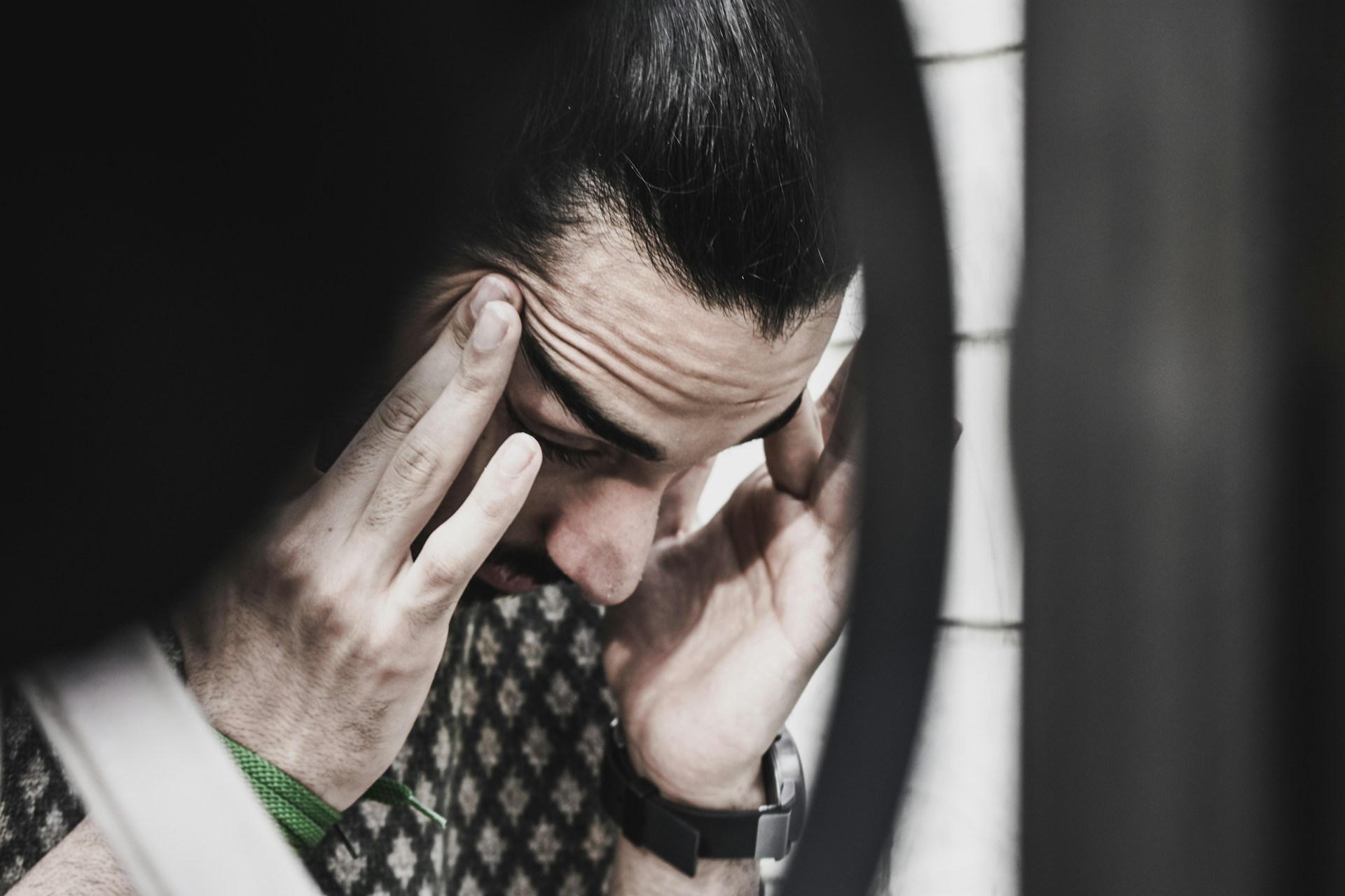 A man rubbing at his temples | Source: Unsplash