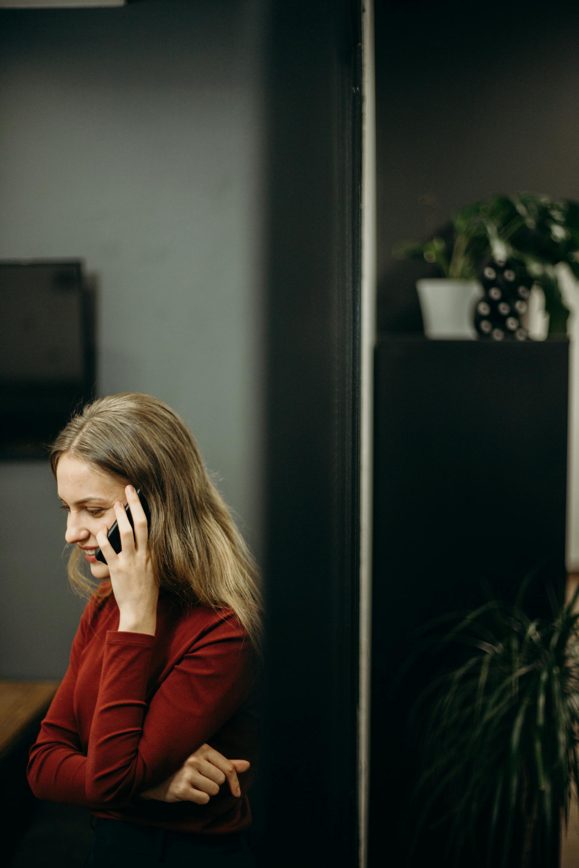 A woman smiling during a phone conversation | Source: Pexels