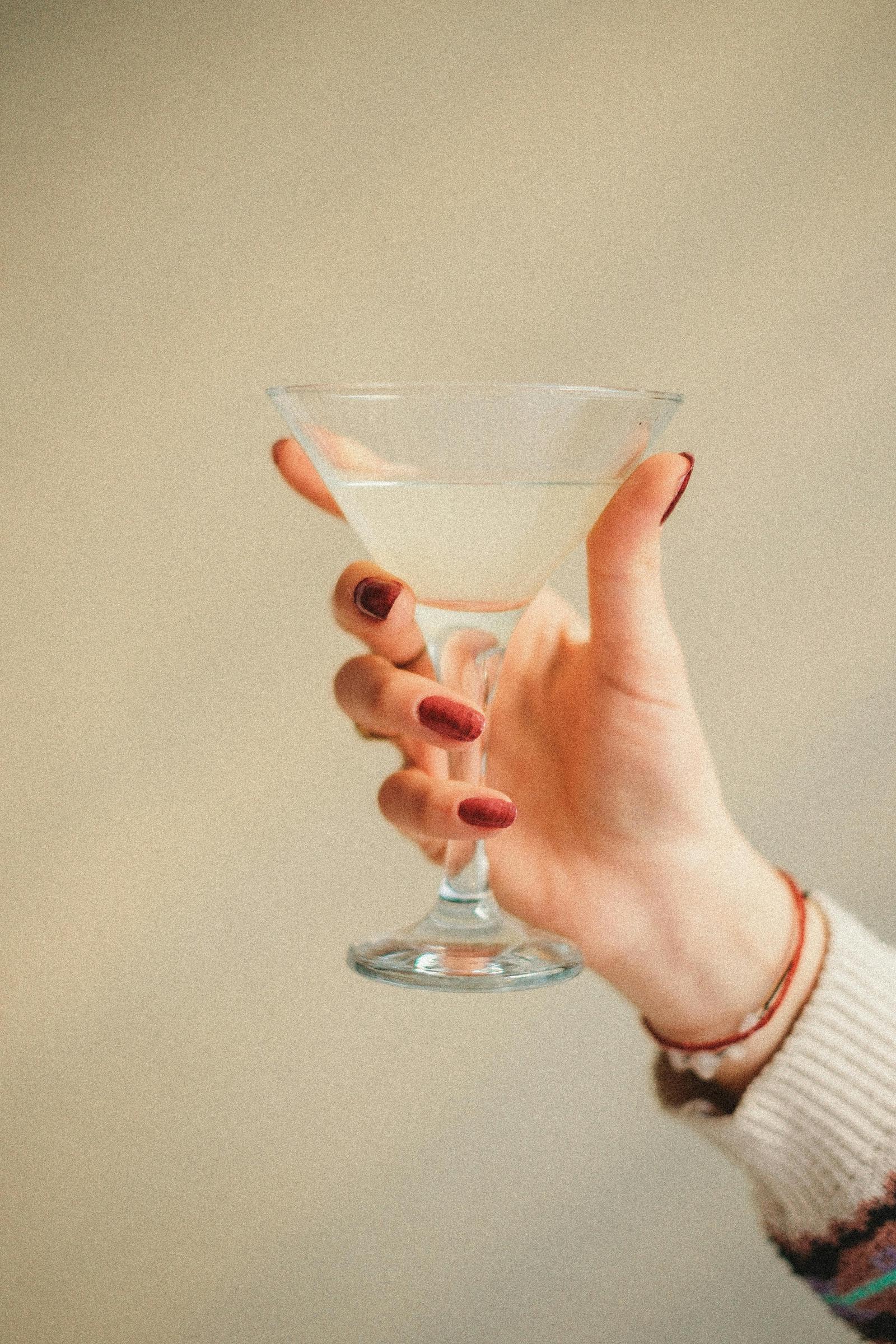 A woman holding up her glass | Source: Pexels