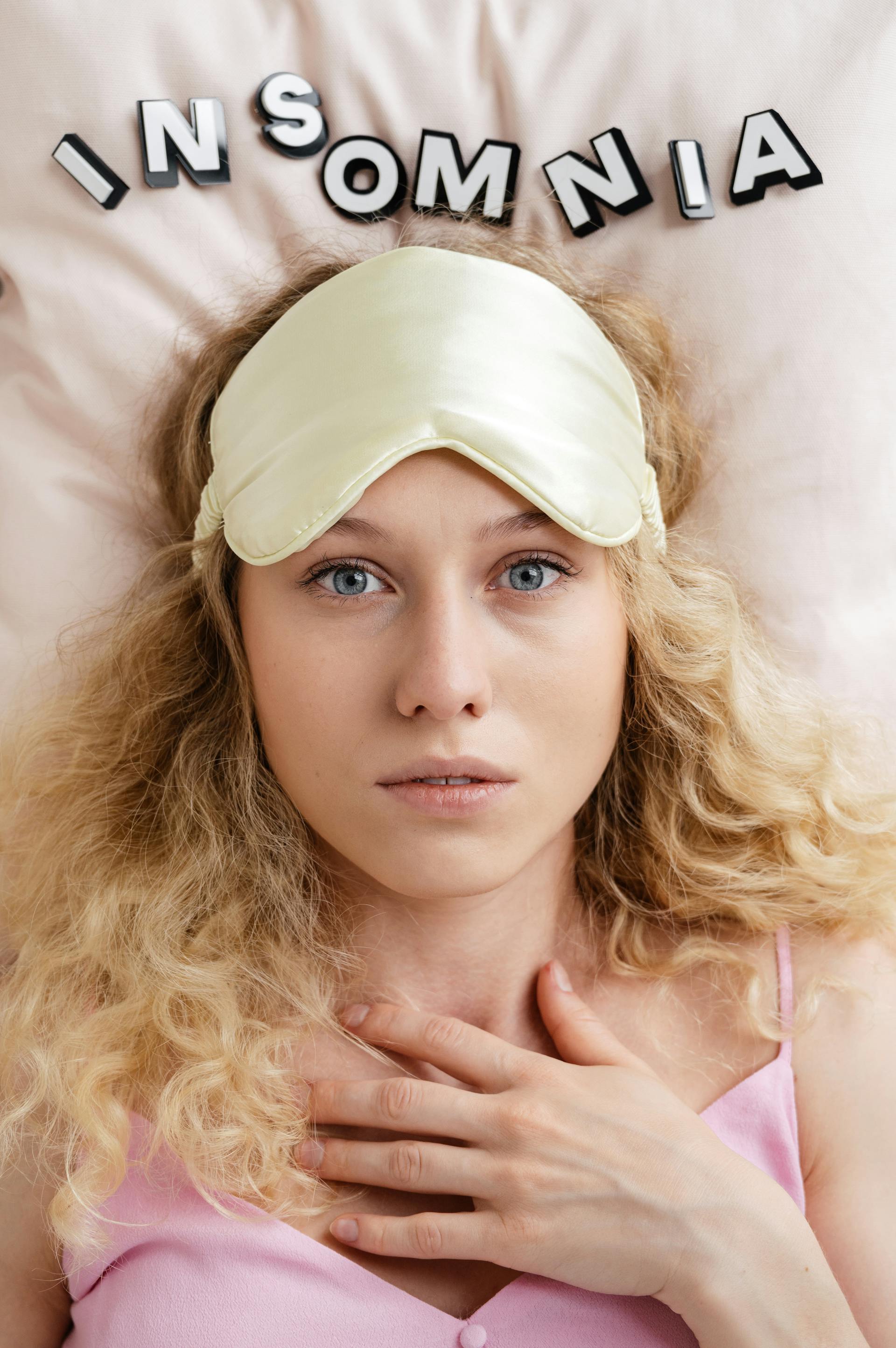 Woman lying awake in bed | Source: Pexels