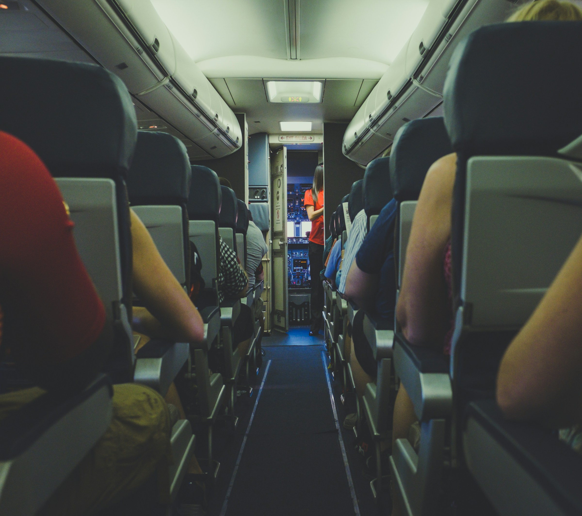 A busy flight attendant on a plane | Source: Unsplash