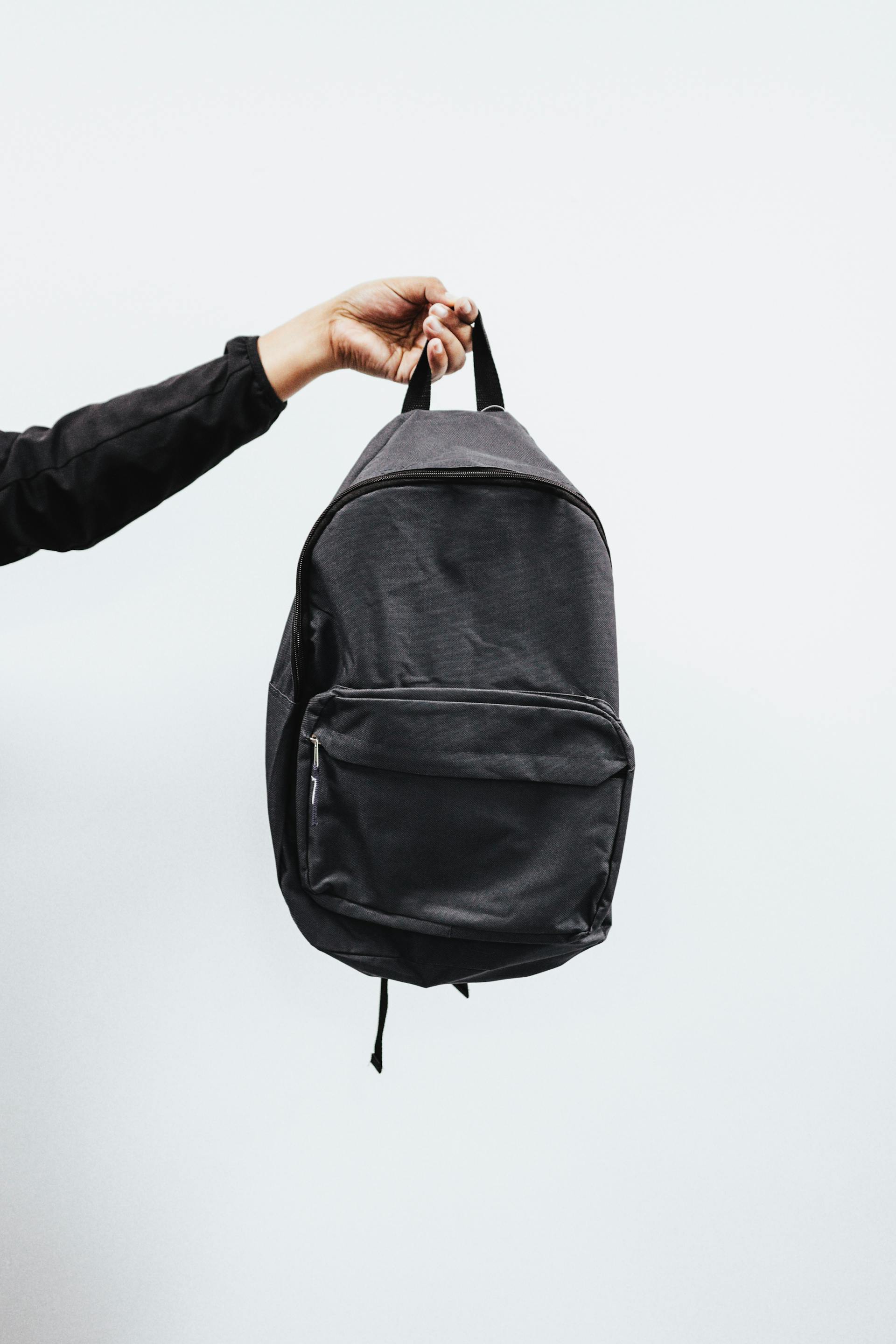 A person holding a backpack | Source: Pexels