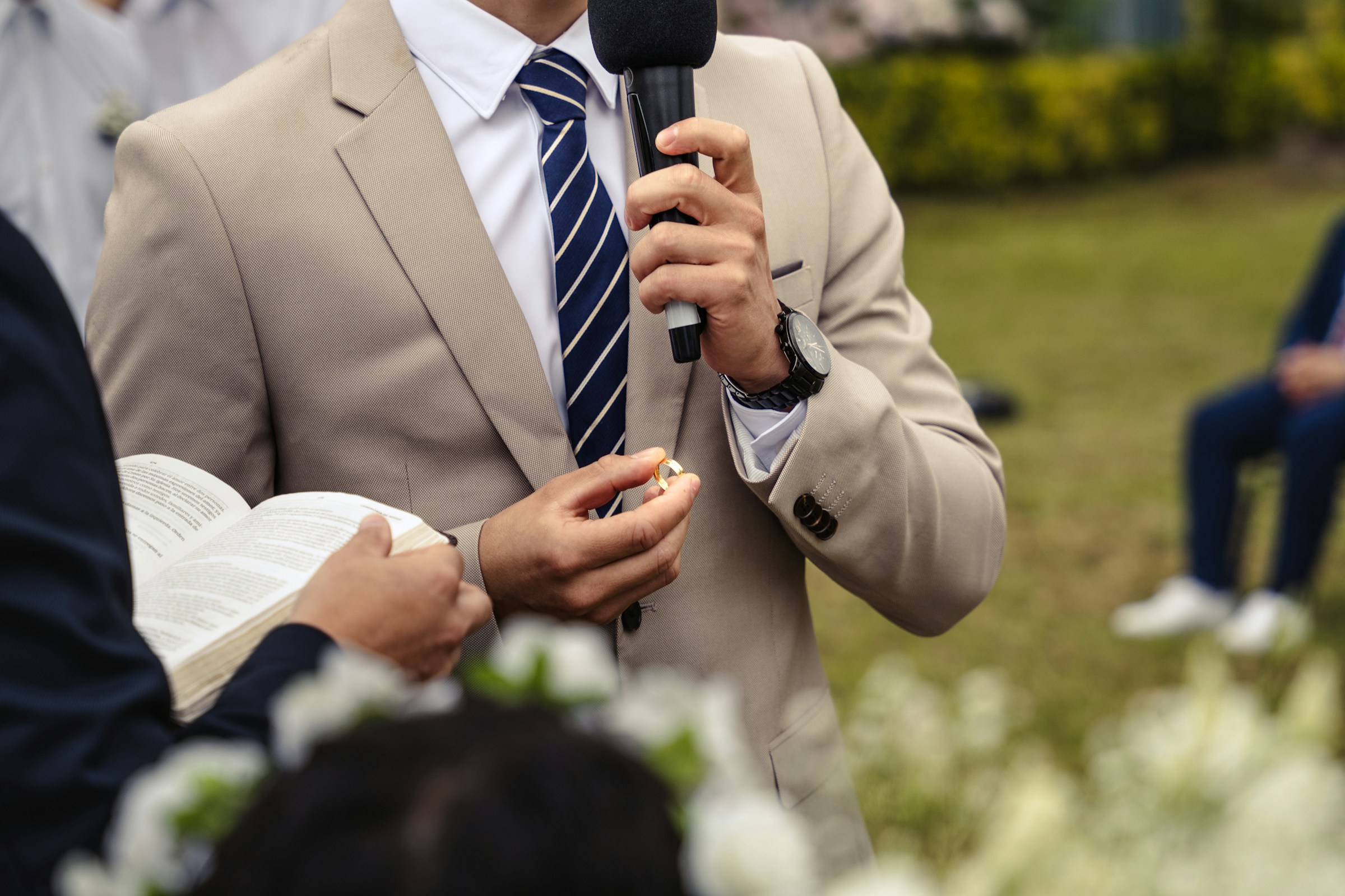 A man in a suit holding a microphone | Source: Unsplash