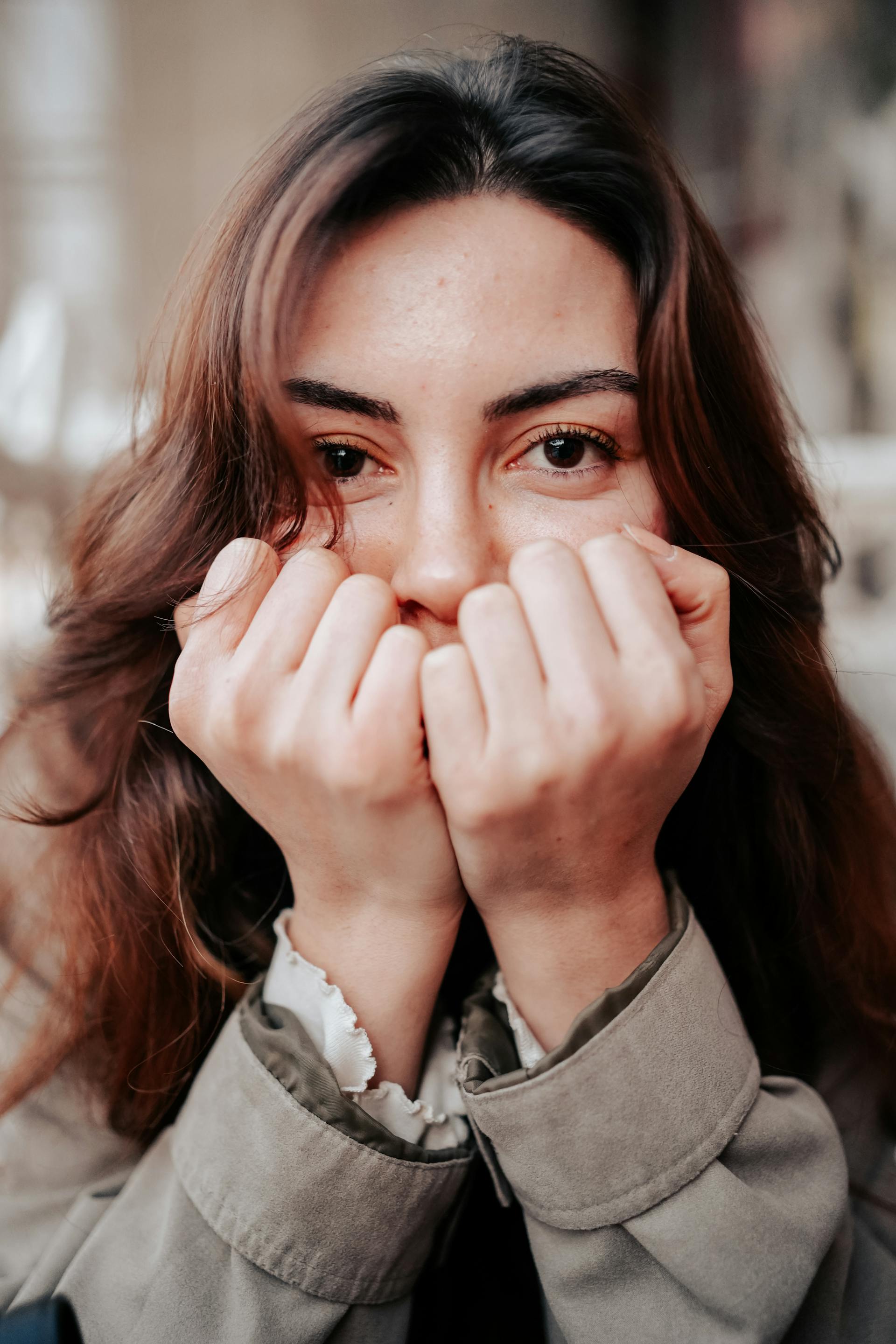 A shocked woman covering her face | Source: Pexels