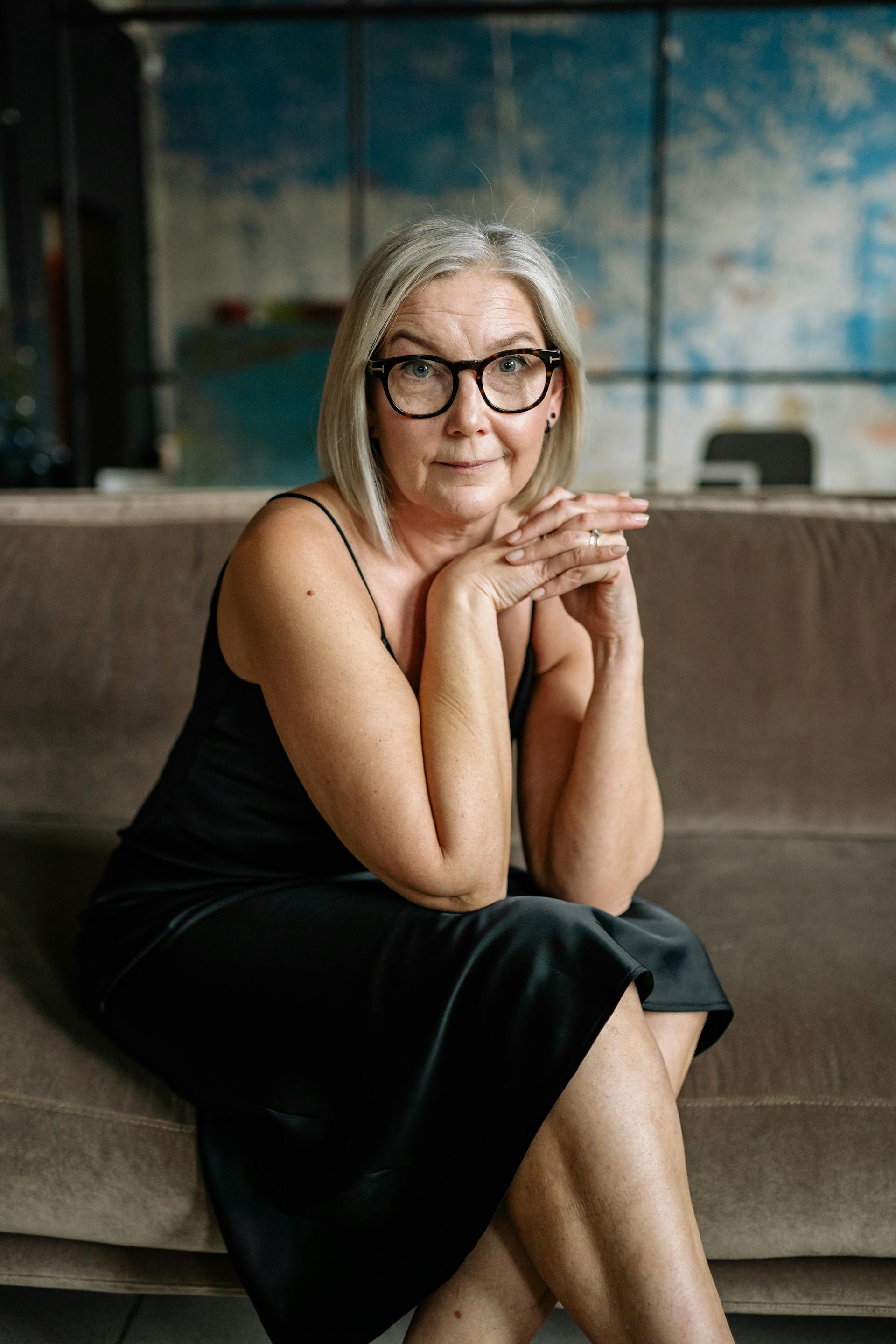 A senior woman sitting on a sofa and looking at someone | Source: Pexels