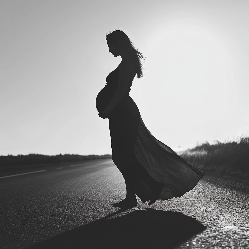 Grayscale shot of a pregnant woman on the road | Source: Midjourney