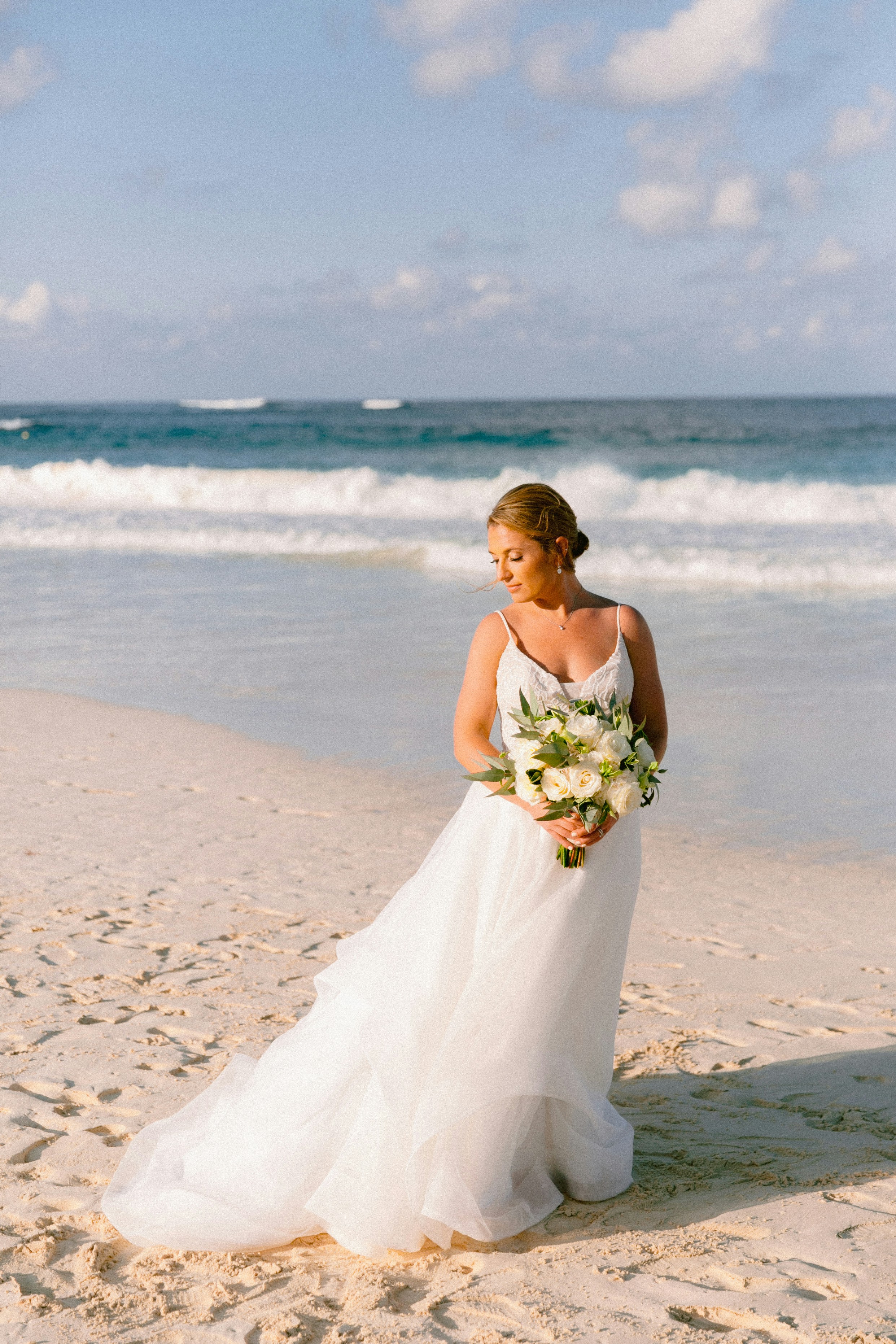 Bride standing on a sandy beach | Source: Unsplash