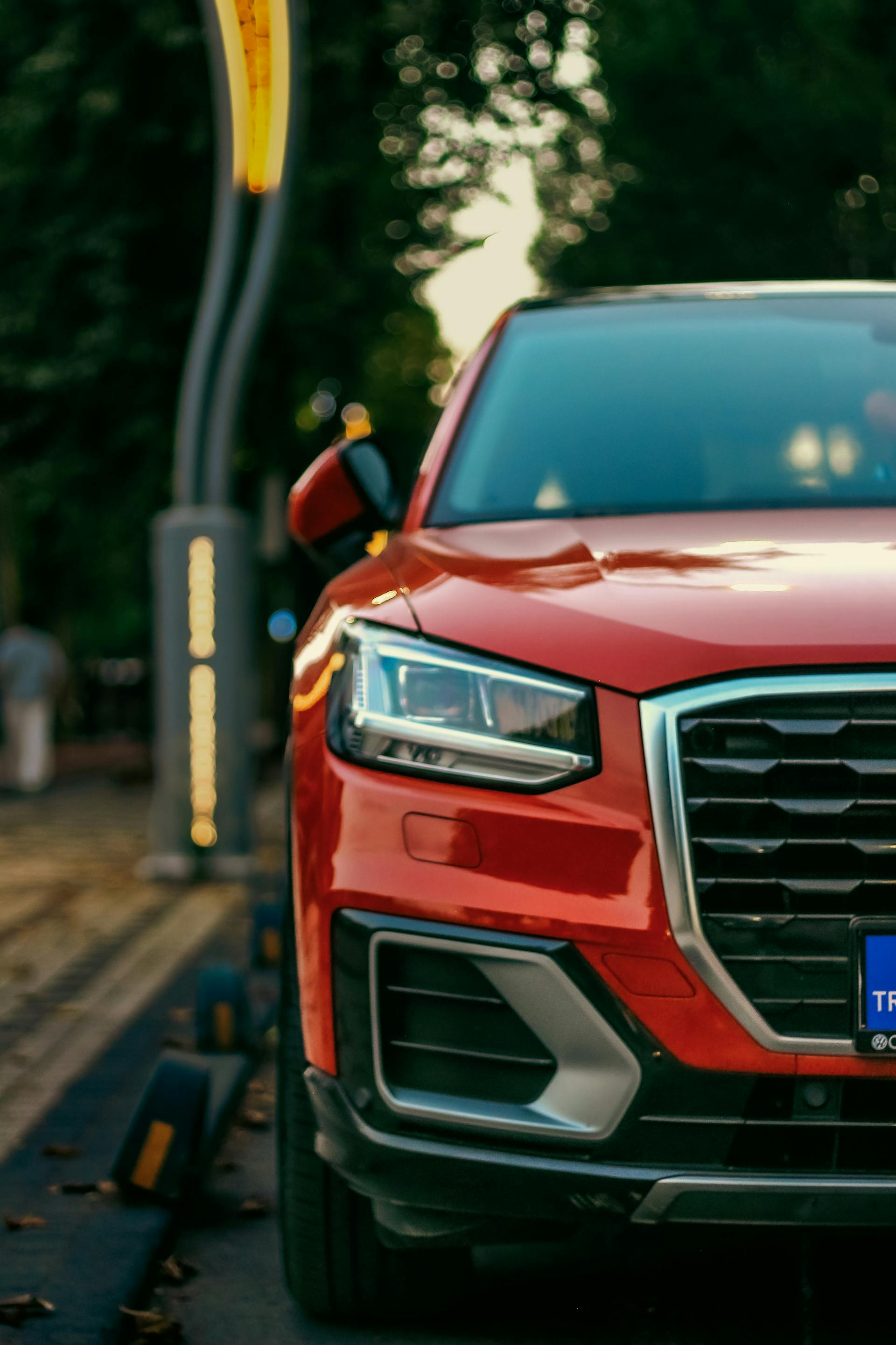 Zbliżenie czerwonego SUV-a zaparkowanego na poboczu drogi | Źródło: Pexels