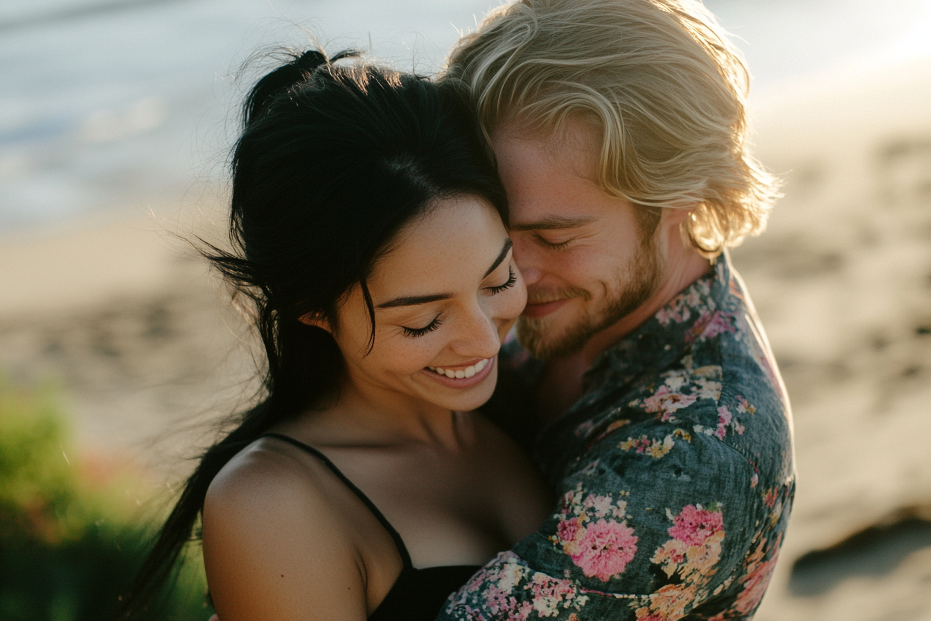 A black-haired woman and a blonde man in their 30s cuddle close on the beach | Source: Midjourney