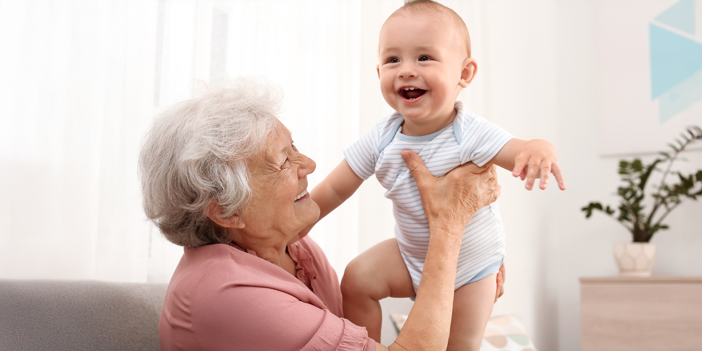 A grandmother holding a baby | Source: Shutterstock