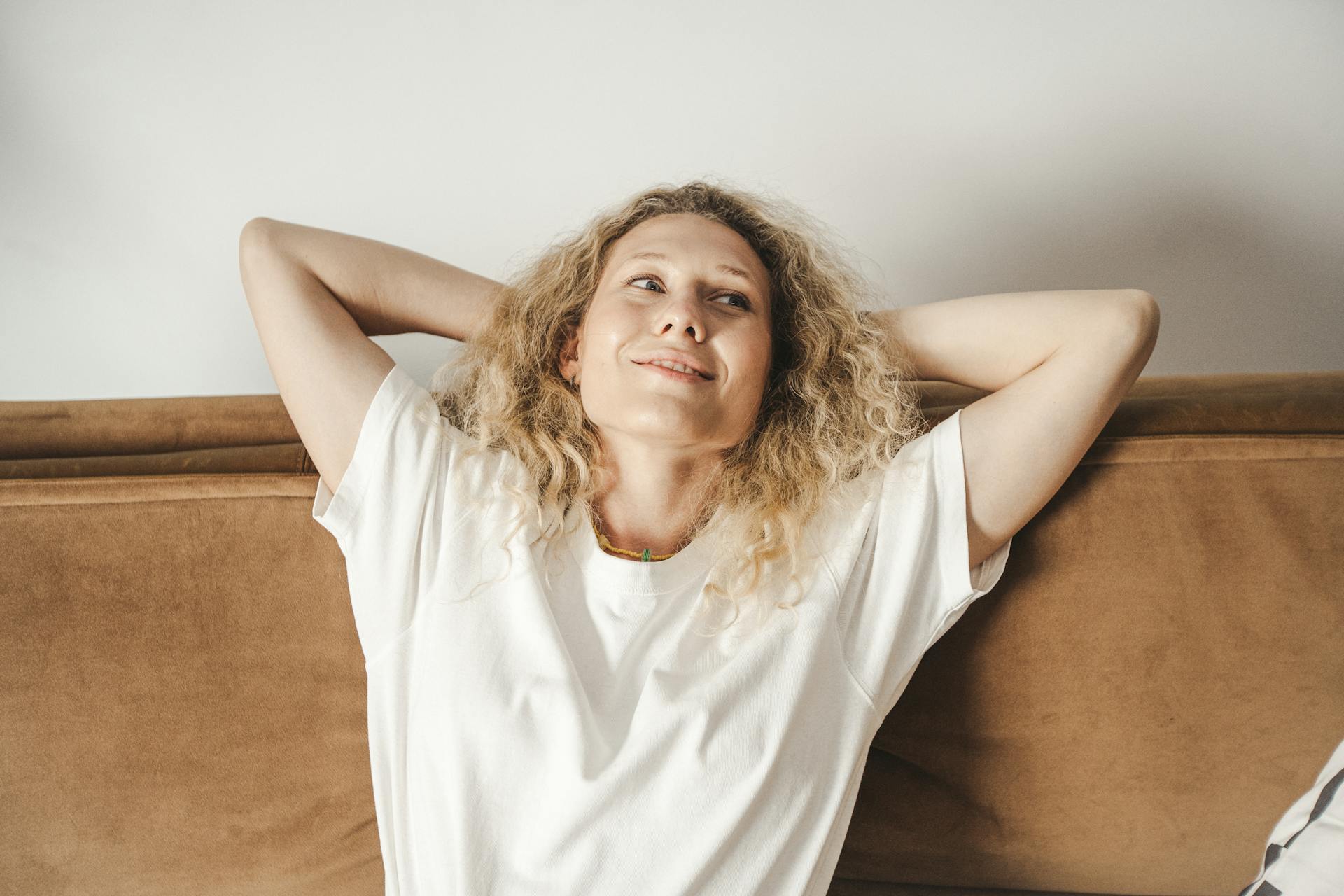 A woman leaning back in satisfaction | Source: Pexels