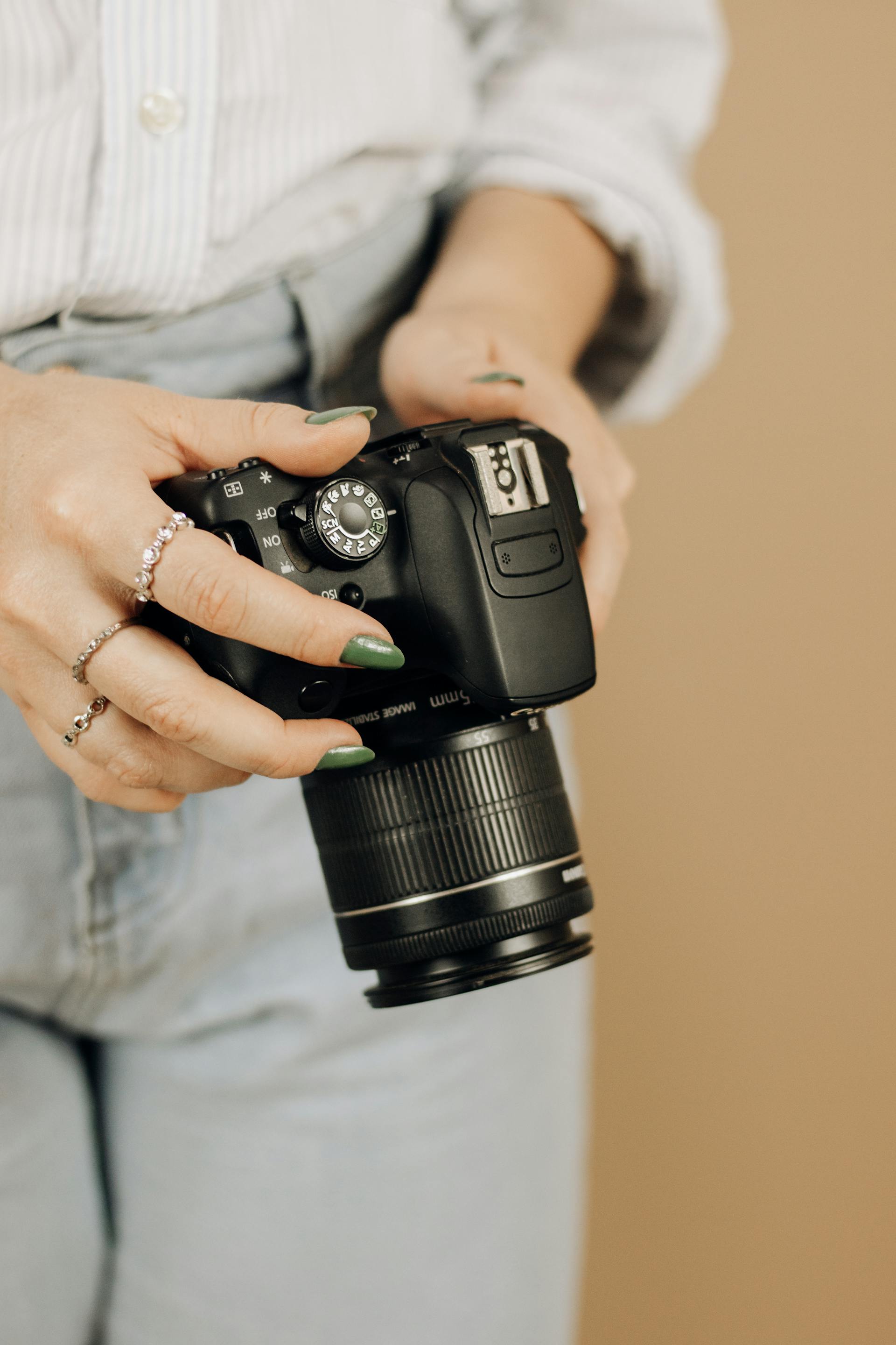 A woman holding her camera | Source: Pexels