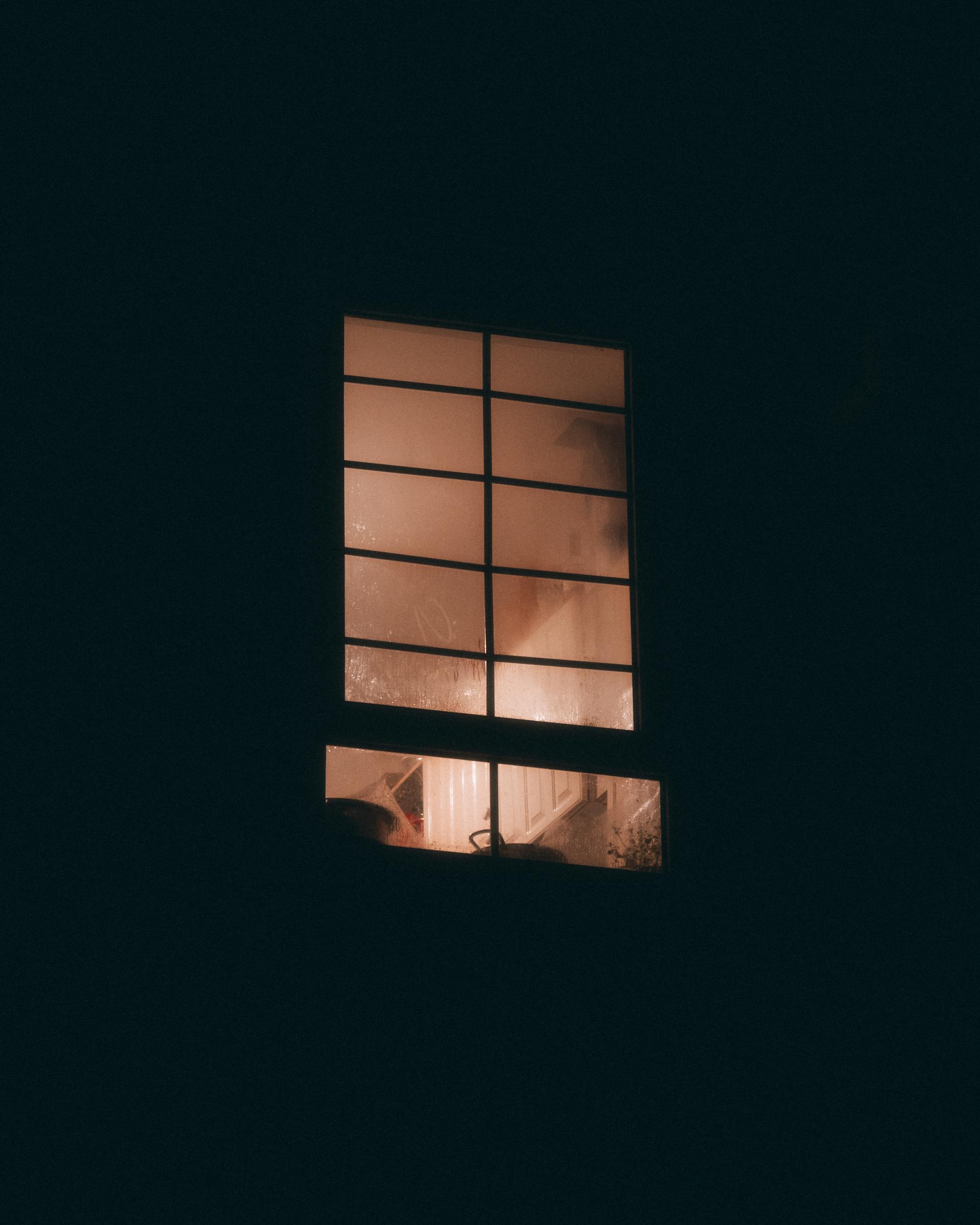 An apartment window at night | Source: Pexels