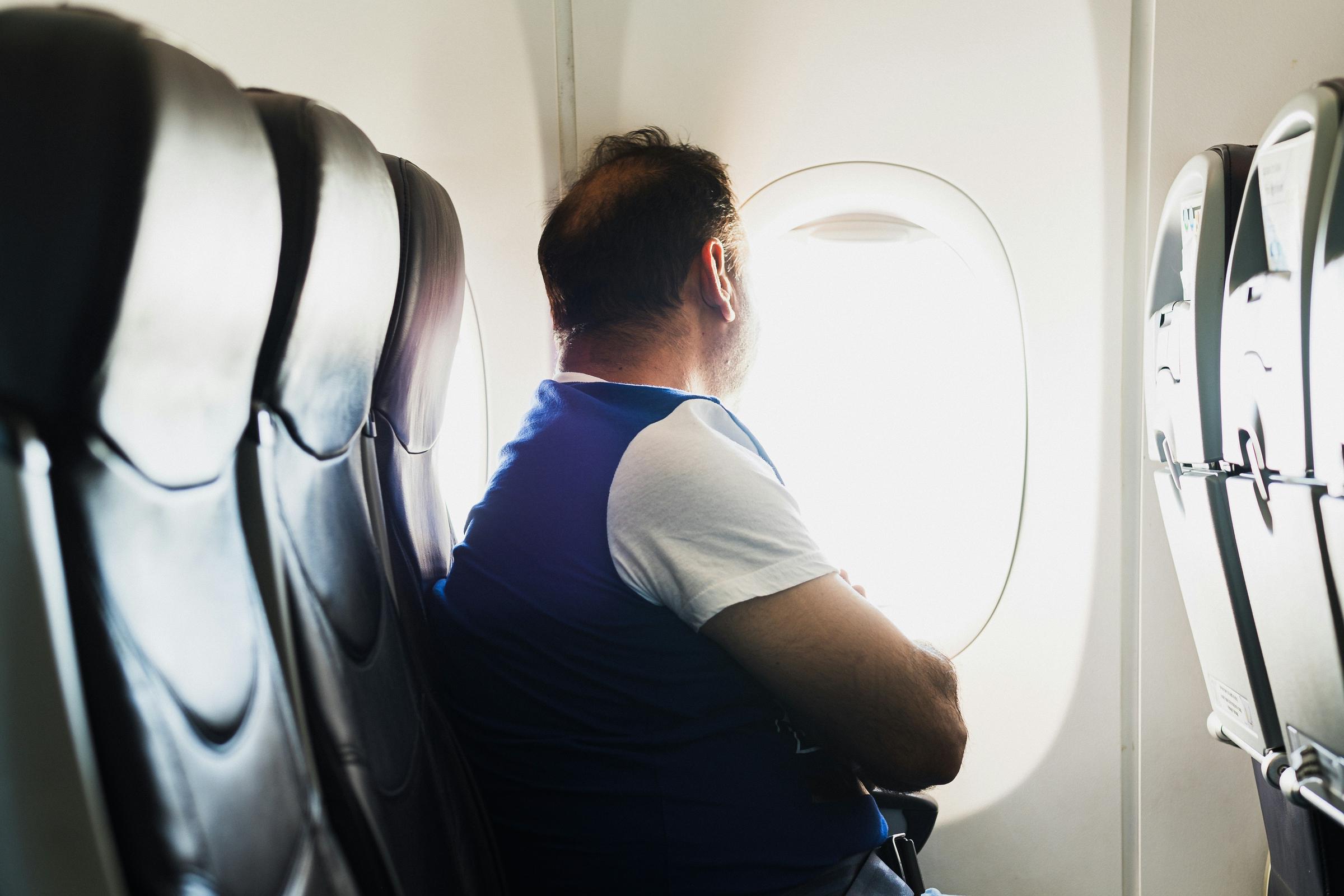 Man inside a plane looking out the window | Source: Unsplash