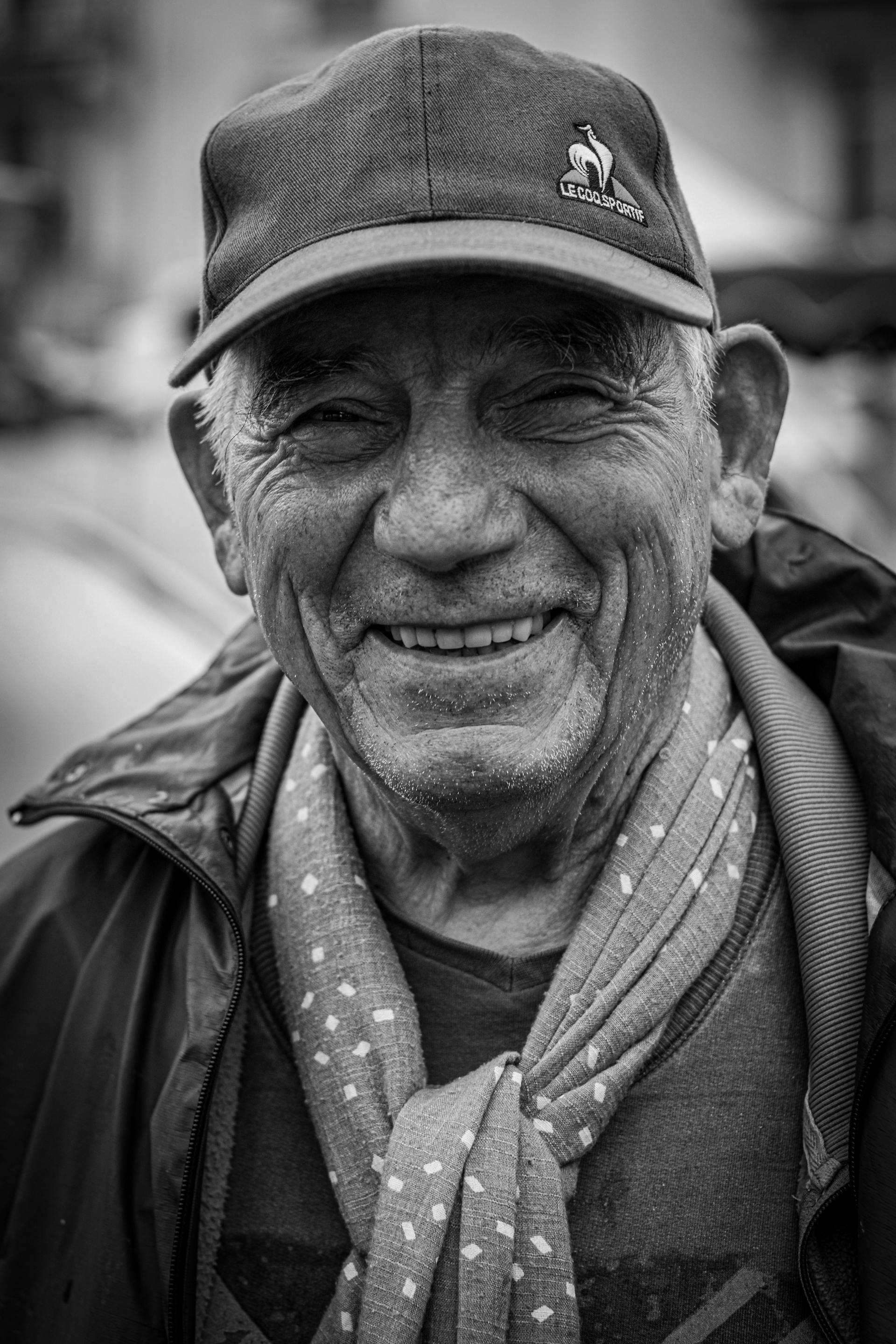 A grayscale photo of a smiling man wearing a cap | Source: Pexels