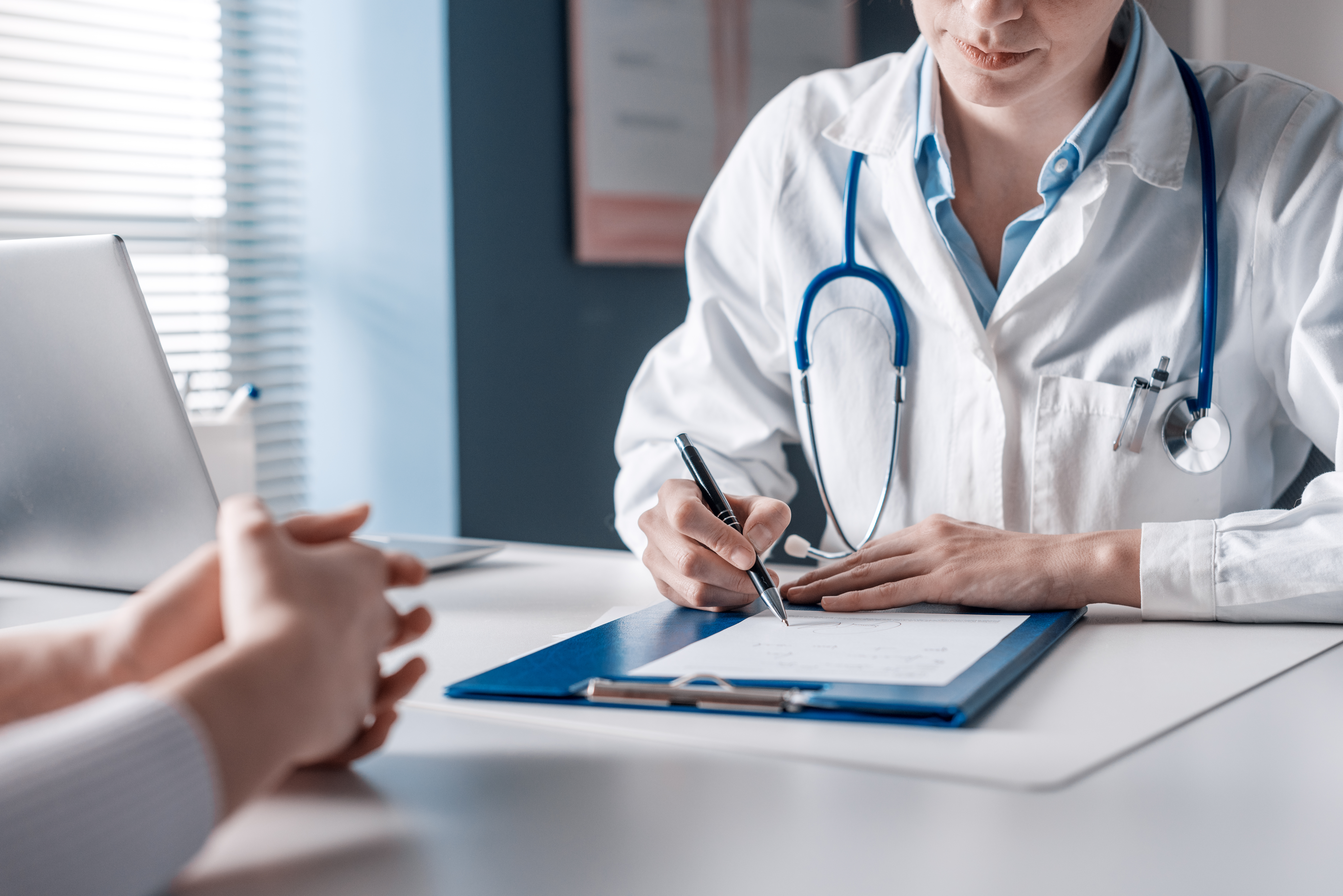 Doctor sitting at desk | Source: Shutterstock