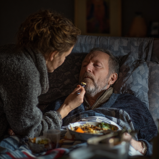 A daughter tending to her sick father | Source: Midjourney